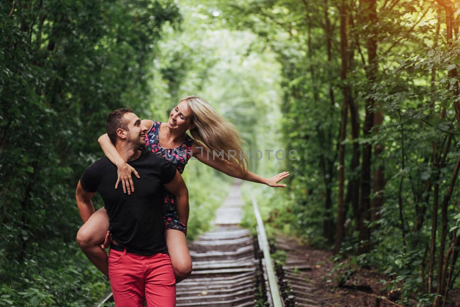 Loving couple in love tunnel iron road.