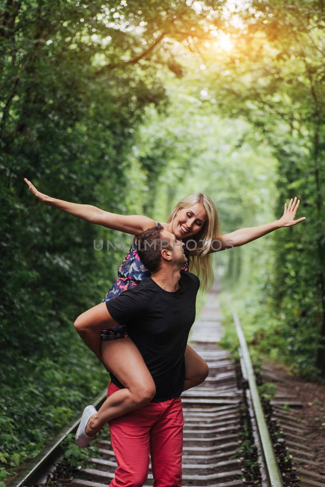 Loving couple in love tunnel iron road.