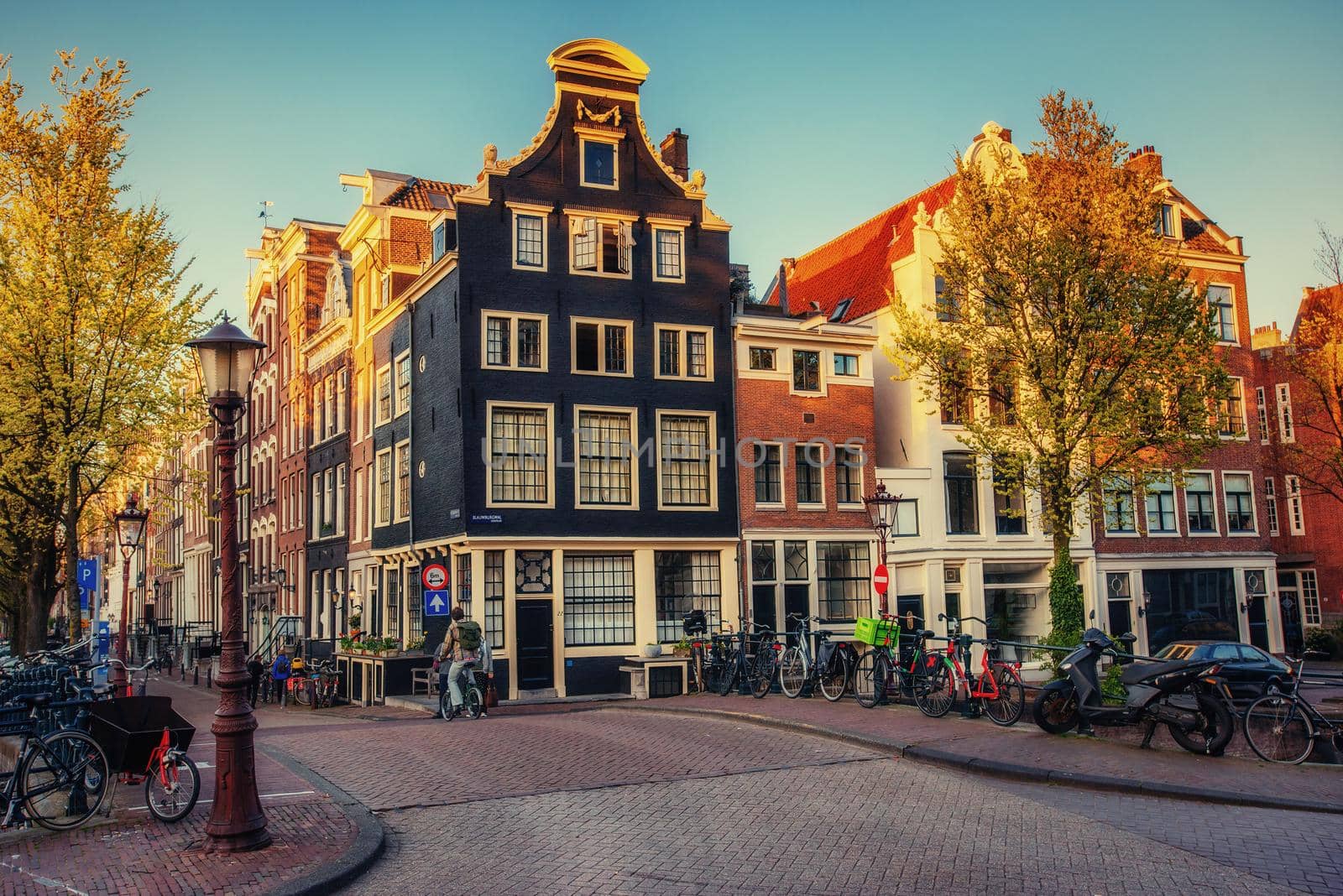 Beautiful tranquil scene of the city of Amsterdam. Bicycles along the street on the bridge over the canal