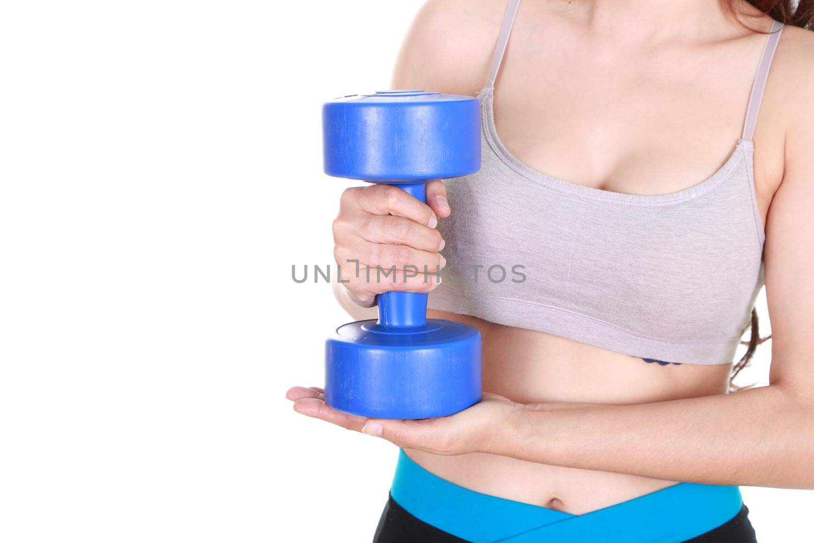 Close up of sporty young woman training with dumbbell on white background