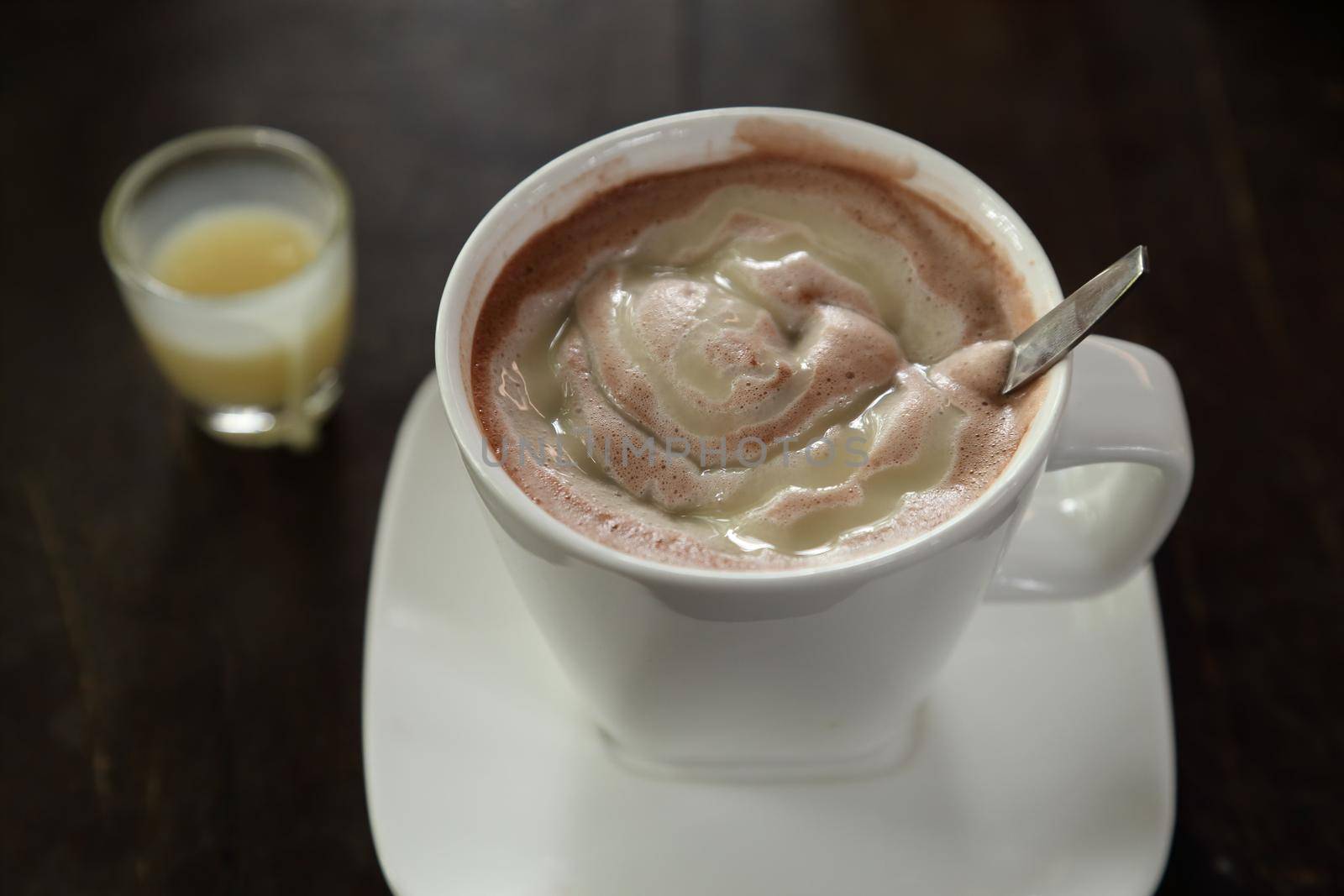 Hot chocolate in a white cup on table by geargodz