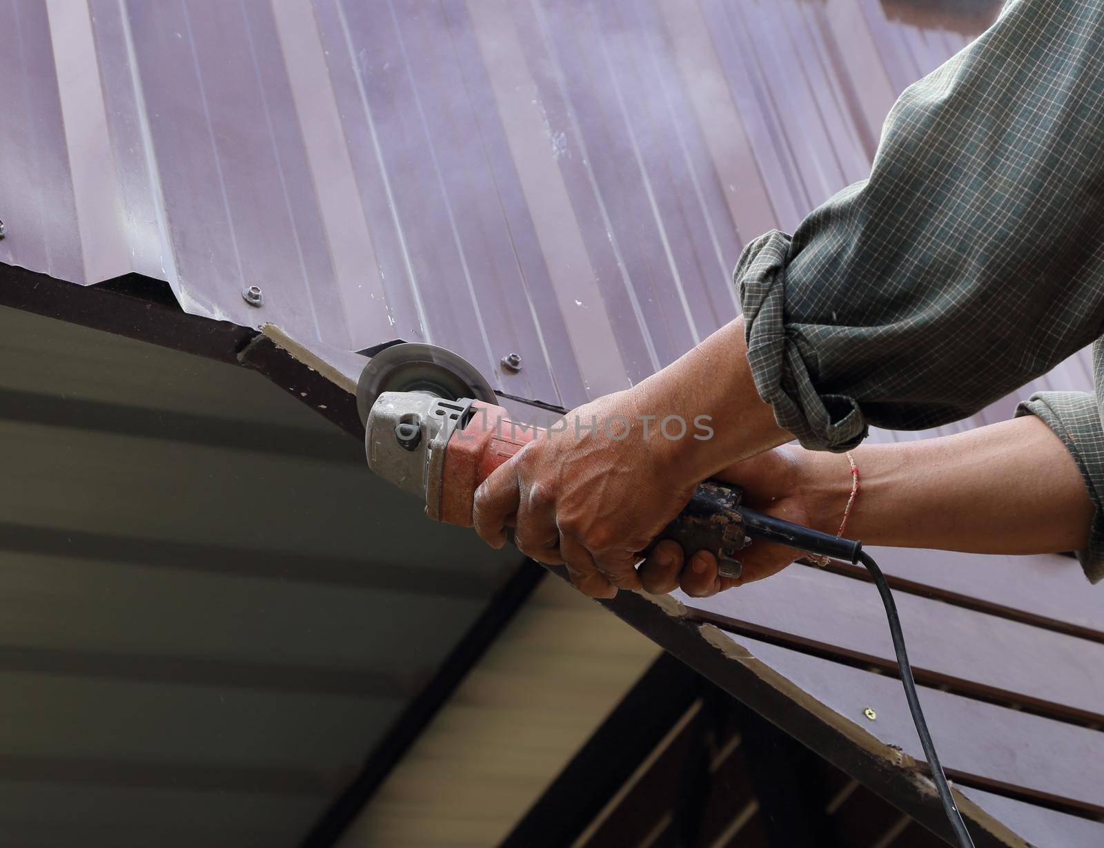 worker use small grinding tool for cutting wood construction 