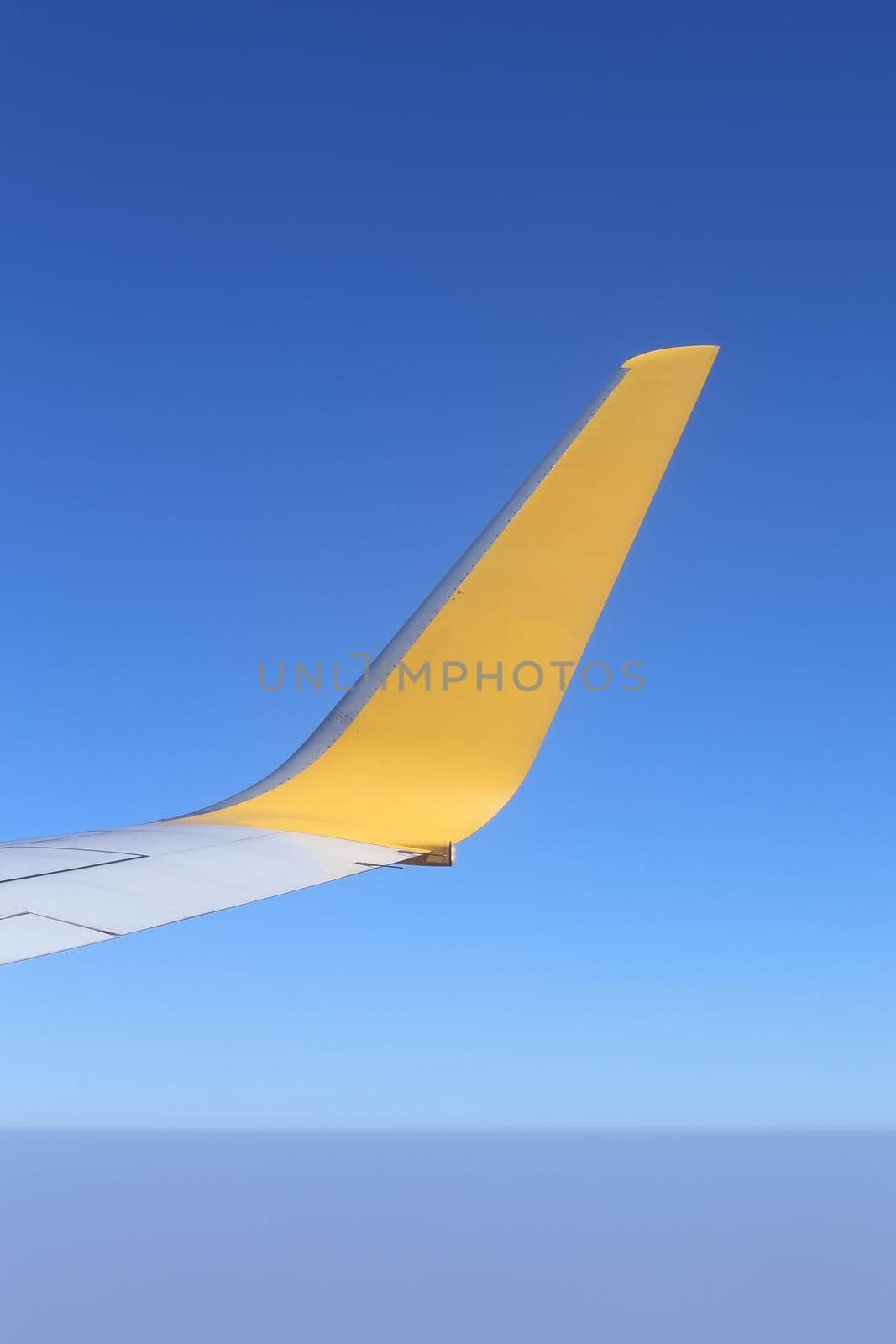 Wing of an airplane flying above the sky