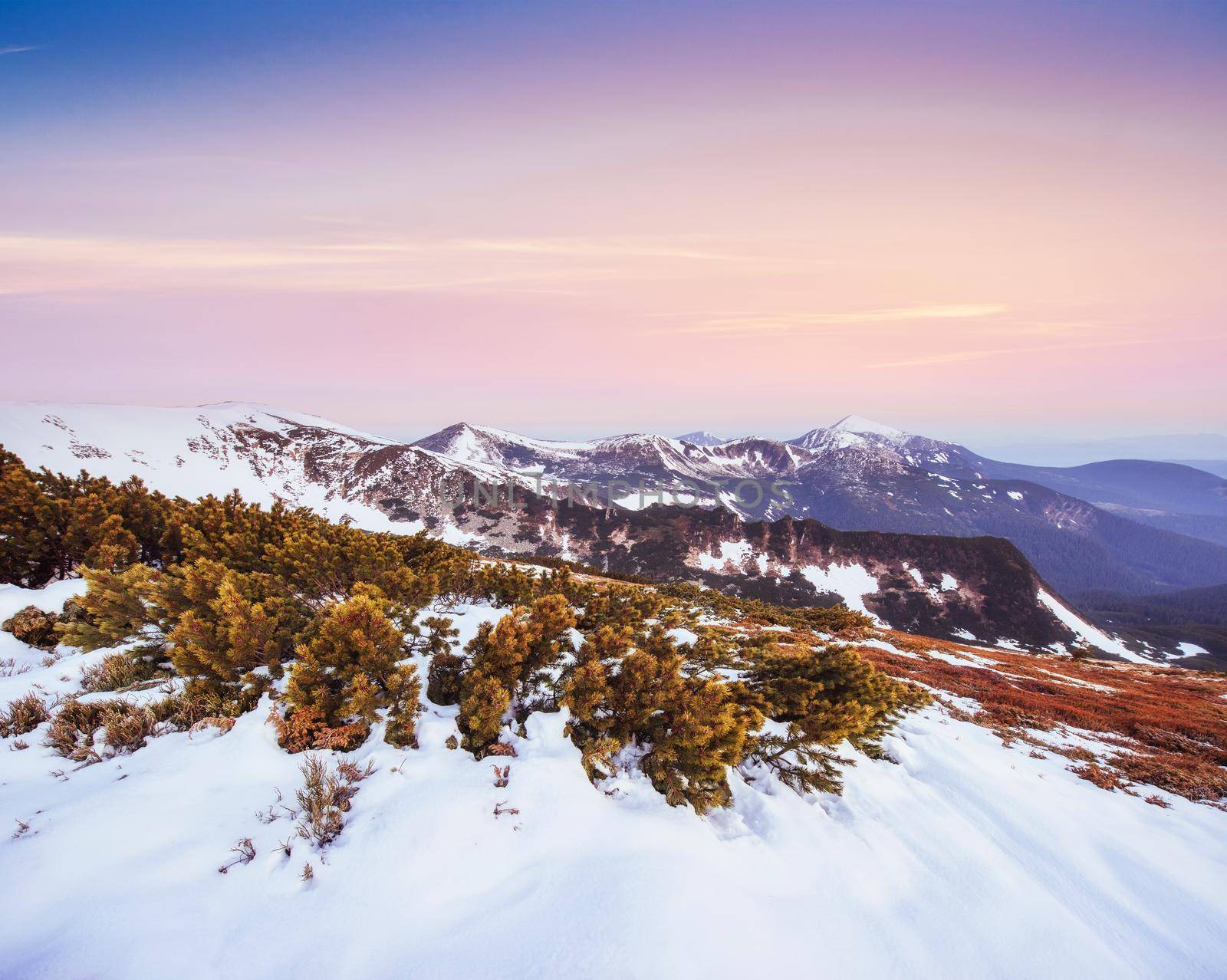 Colorful spring sunset over the mountain ranges in the national park Carpathians. Ukraine, Europe.