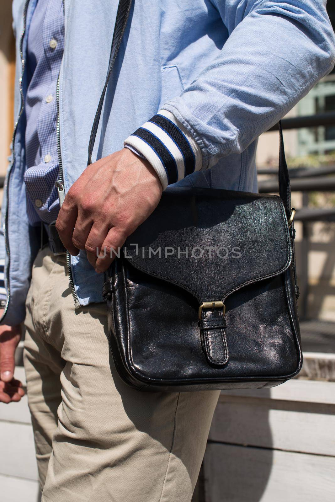 close-up photo of black leather bag . outdoors photo