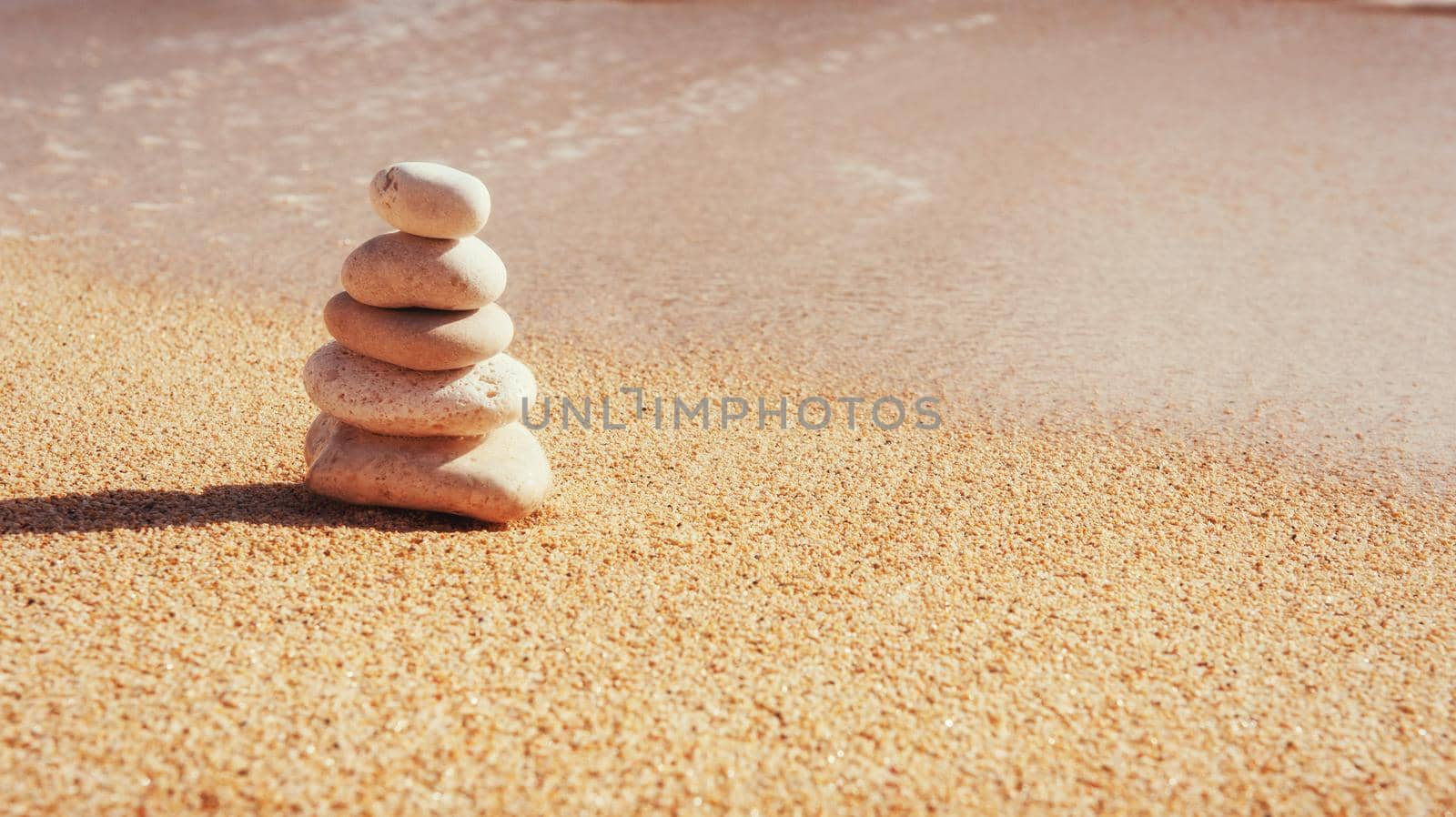 Scenic view of sandy beach and surf waves on the shore