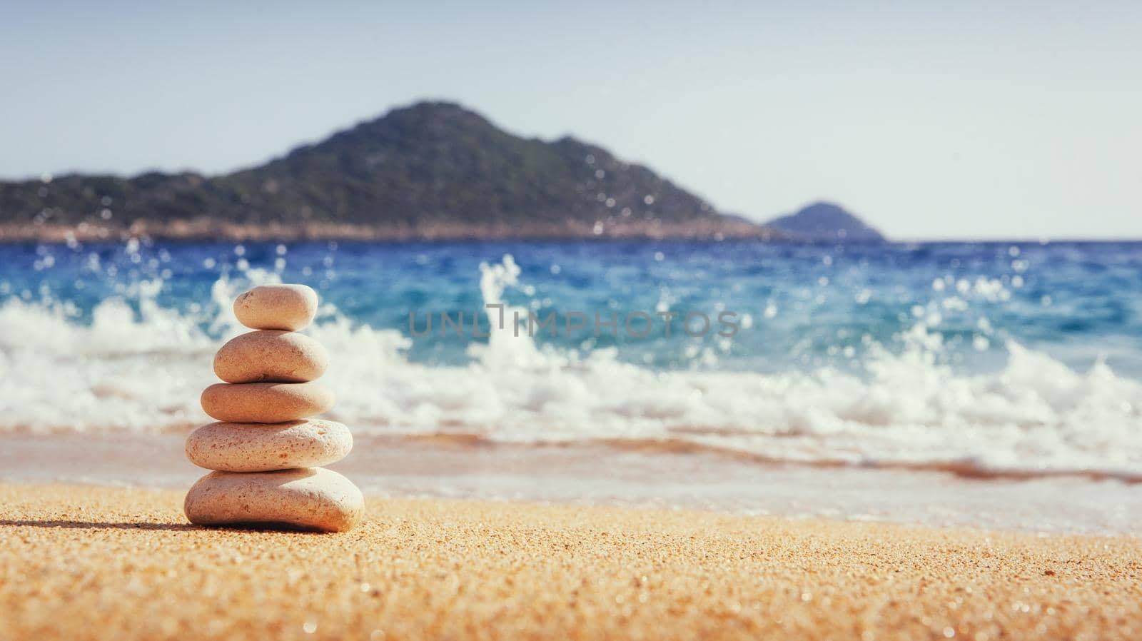Scenic view of sandy beach and surf waves on the shore