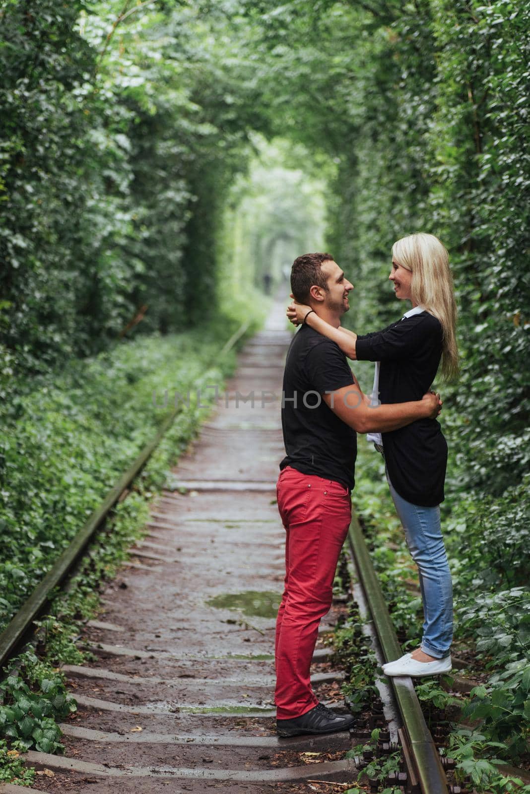 Loving couple on the iron road. Ukraine. Klevan