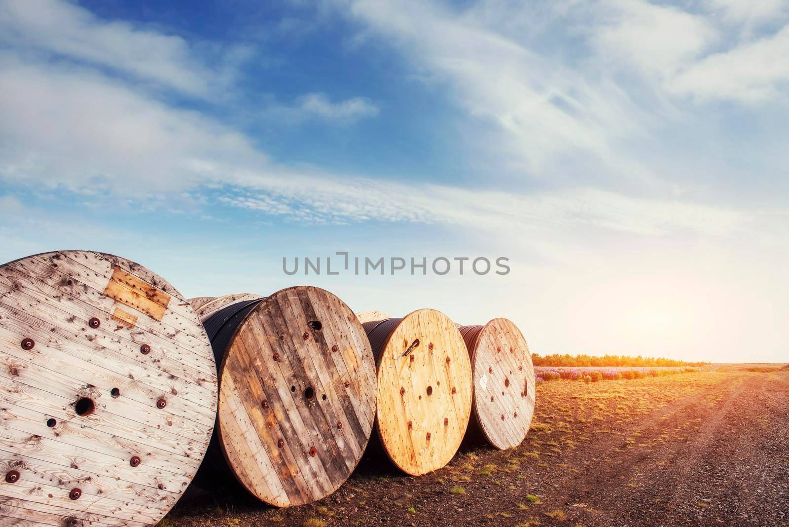 Large rolls of black wires against the blue sky at sunset