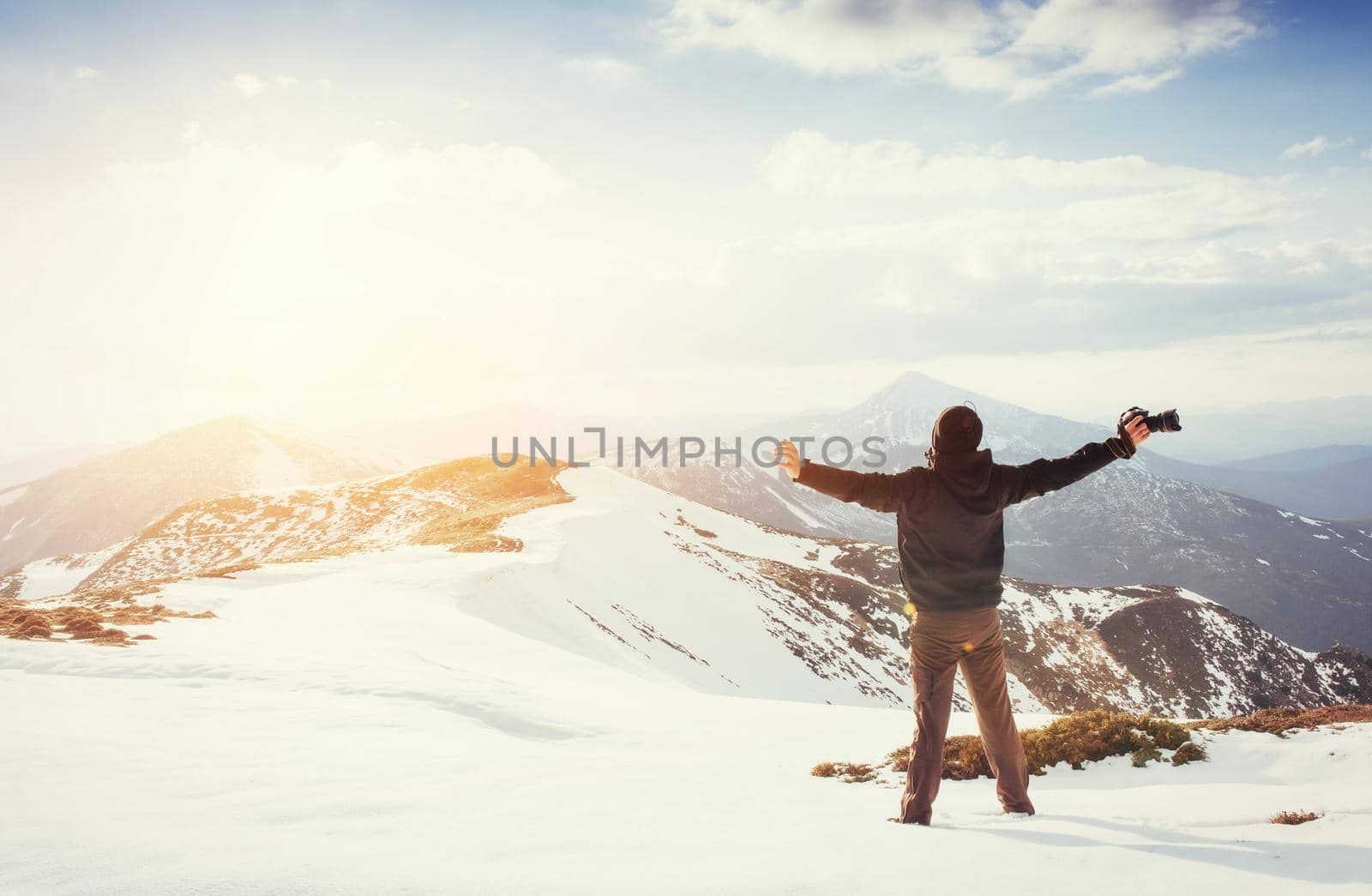 tourist looks at the landscape. Photographer on top of mountain. Spring landscape. Carpathians Ukraine Europe