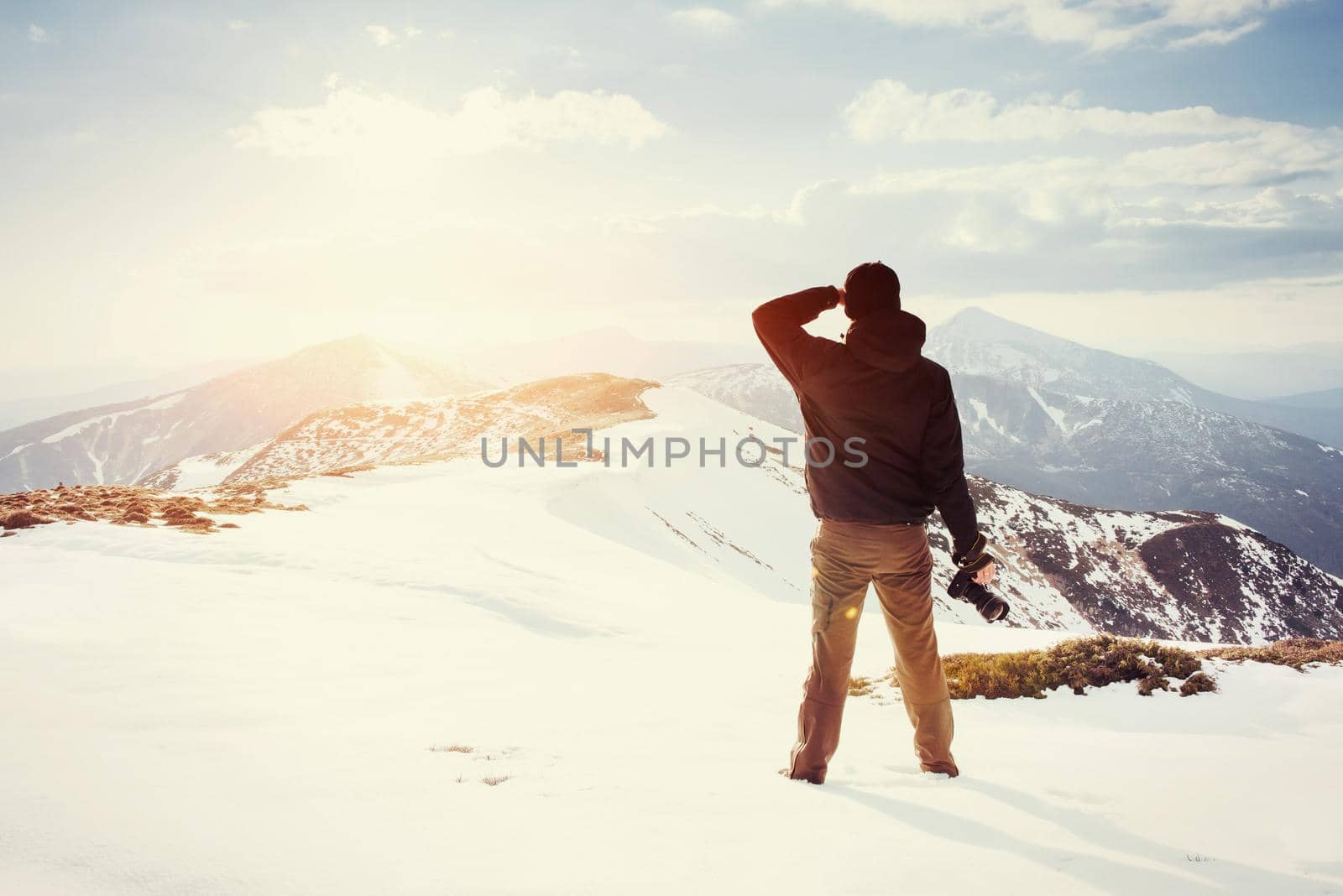 tourist looks at the landscape. Photographer on top of mountain. Spring landscape. Carpathians Ukraine Europe