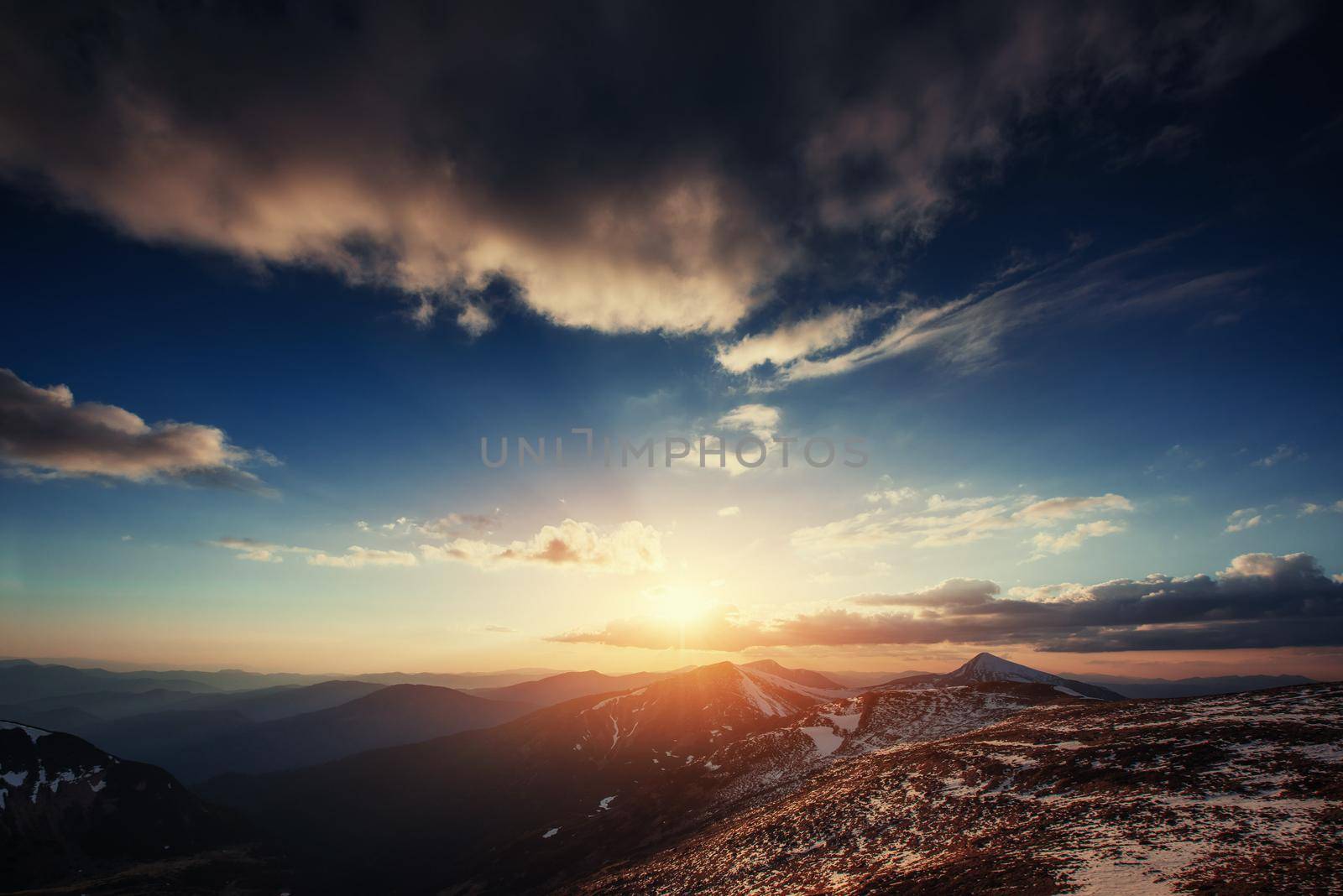 Colorful spring sunset over the mountain ranges in the national park Carpathians. Ukraine, Europe.