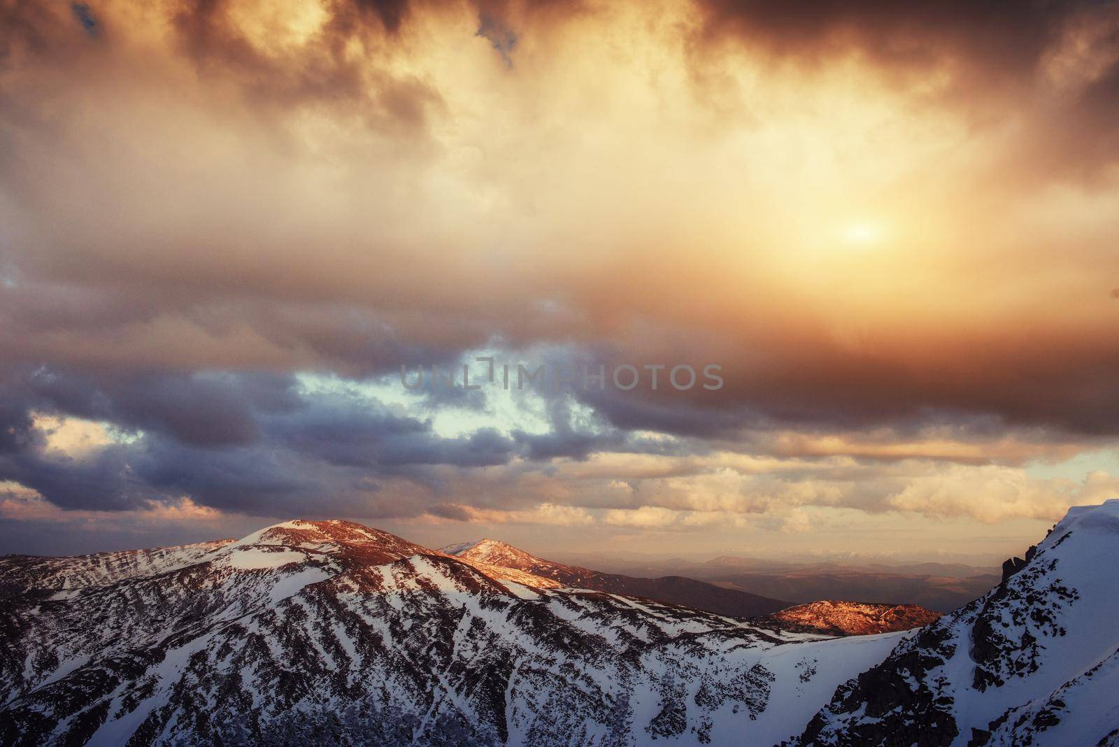 Colorful spring sunset over the mountain ranges in the national park Carpathians. Ukraine, Europe.