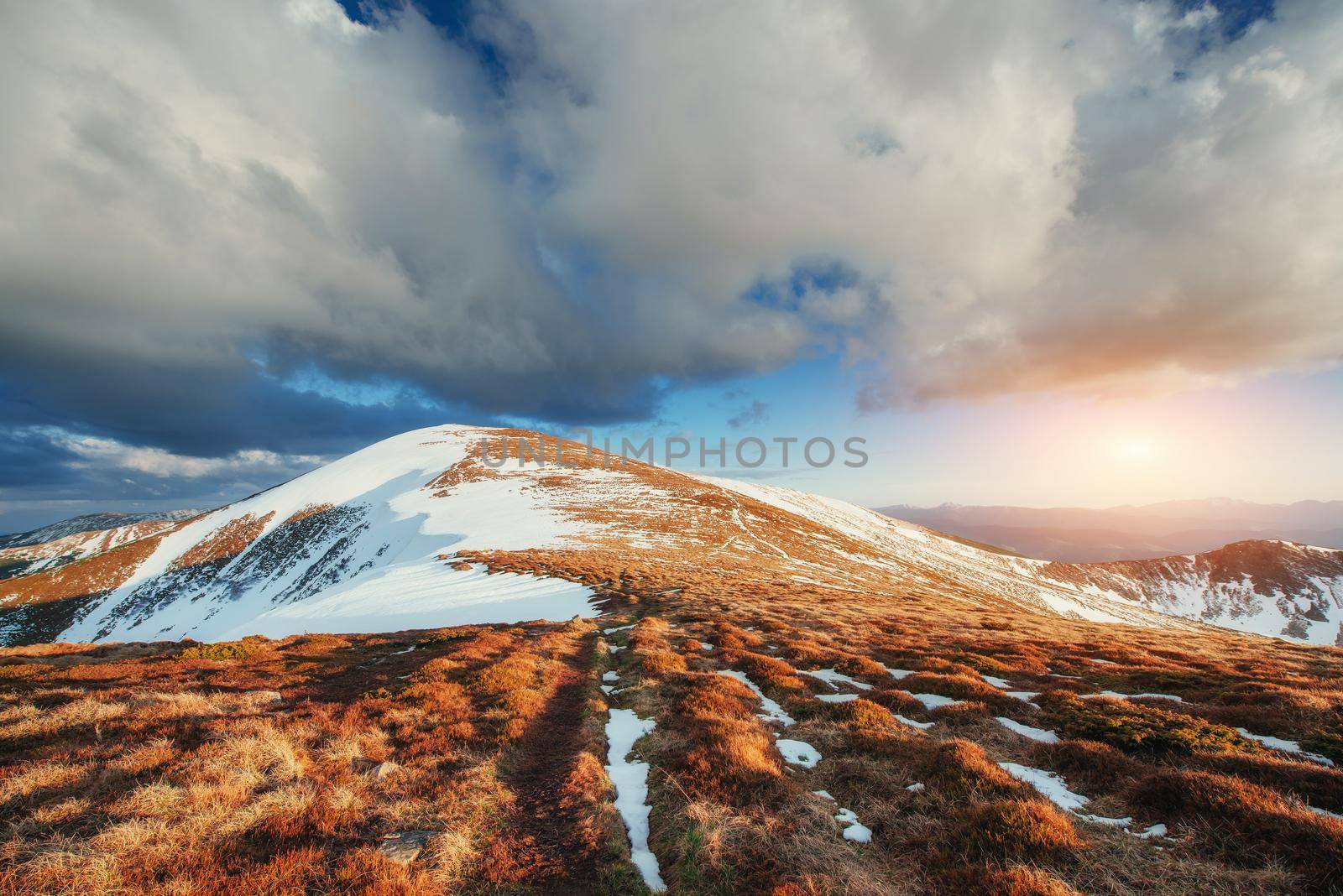 Spring mountain landscape. Snowy Mountains. Beautiful cumulus clouds. Carpathians Ukrain Europe