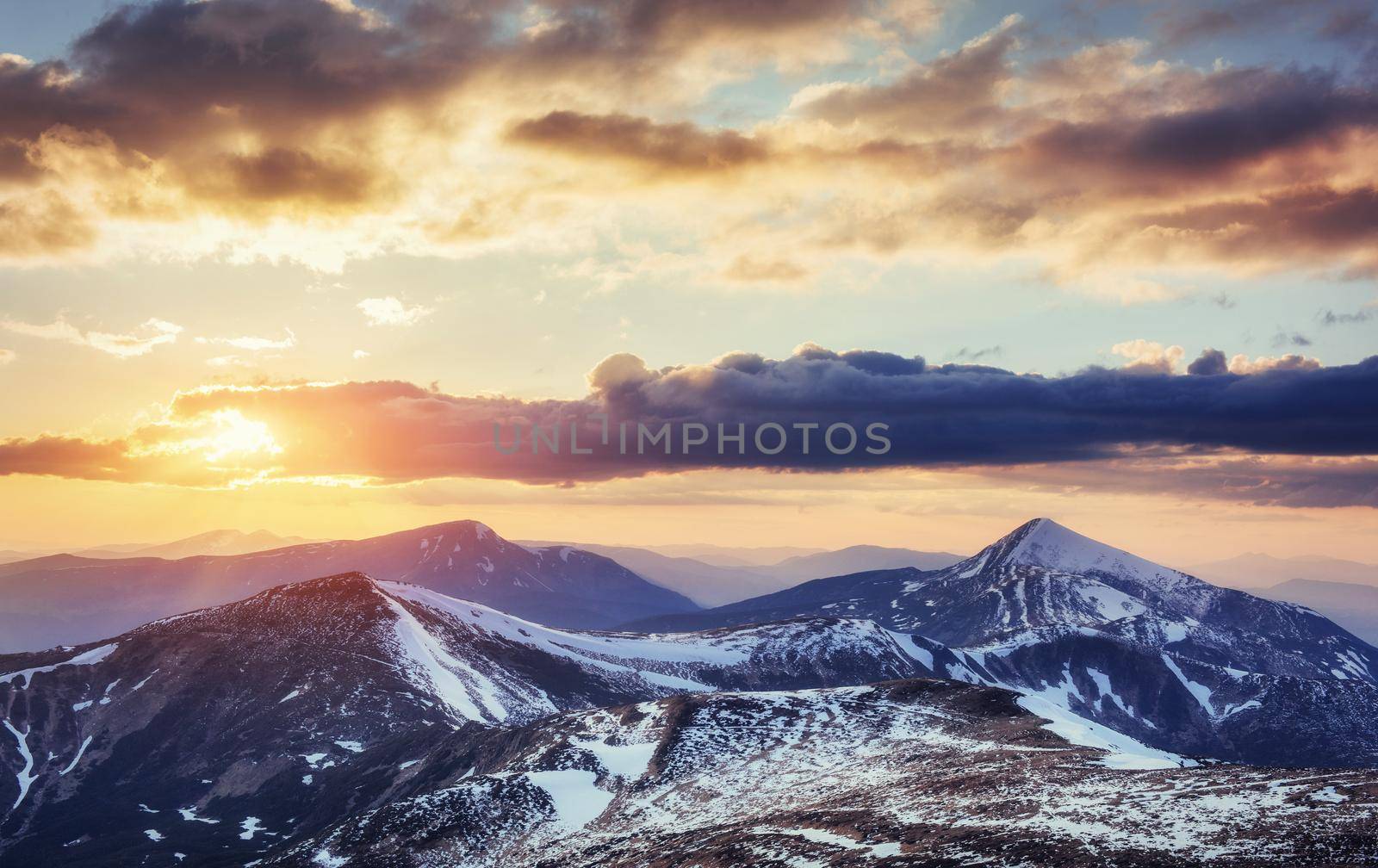 Colorful spring sunset over the mountain ranges in the national park Carpathians. Ukraine, Europe.