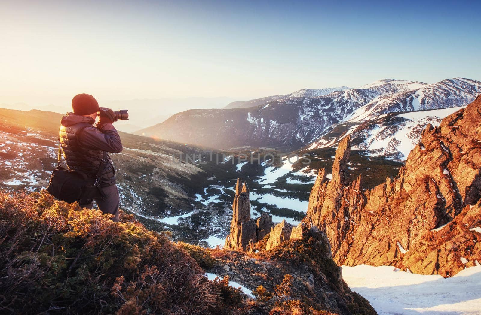 tourist looks at the landscape. Beautiful sunset. Spring landscape. Carpathians Ukraine Europe