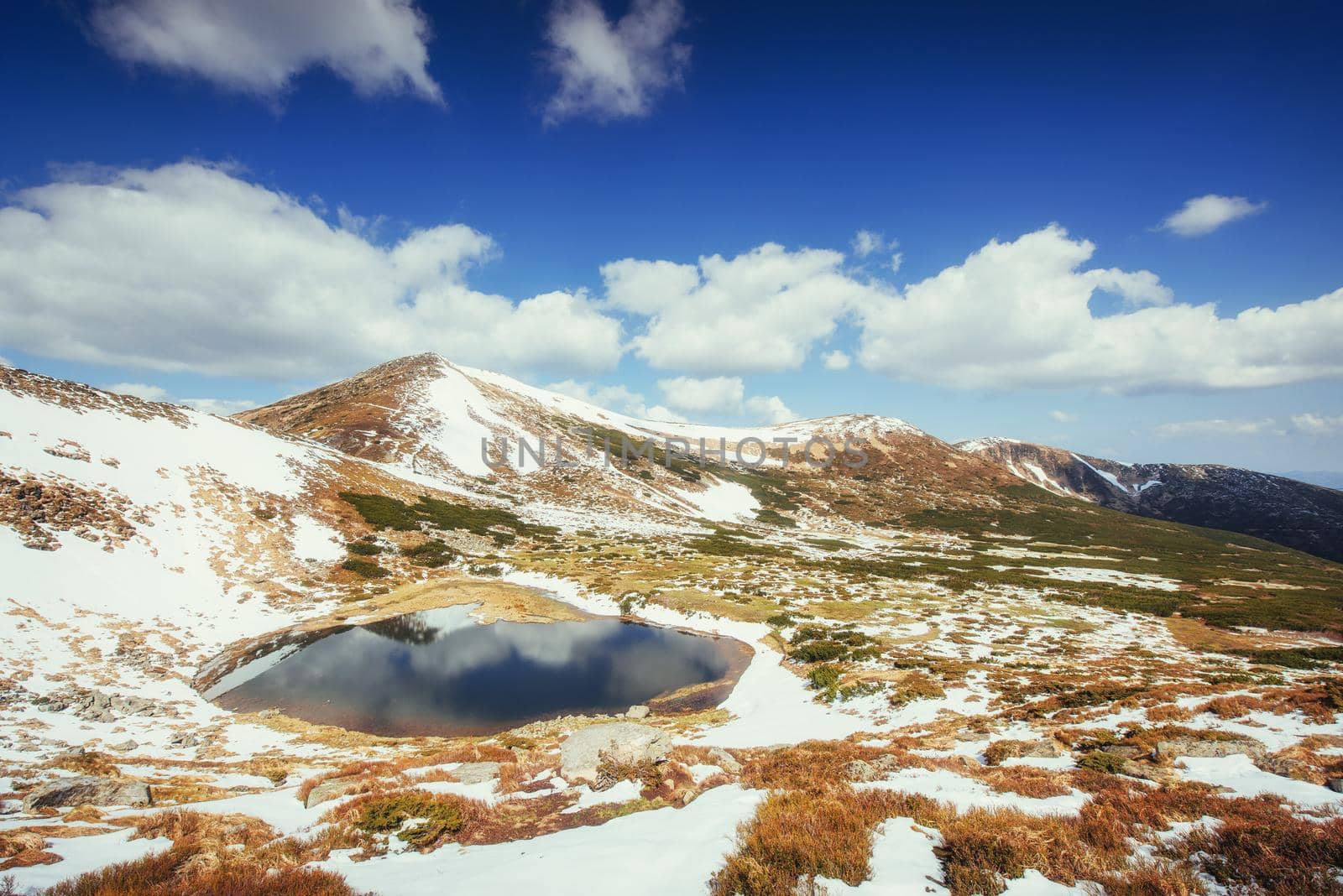 Mountain Lake. Reflection of sky in water. Spring landscape. Carpathians Ukraine Europe