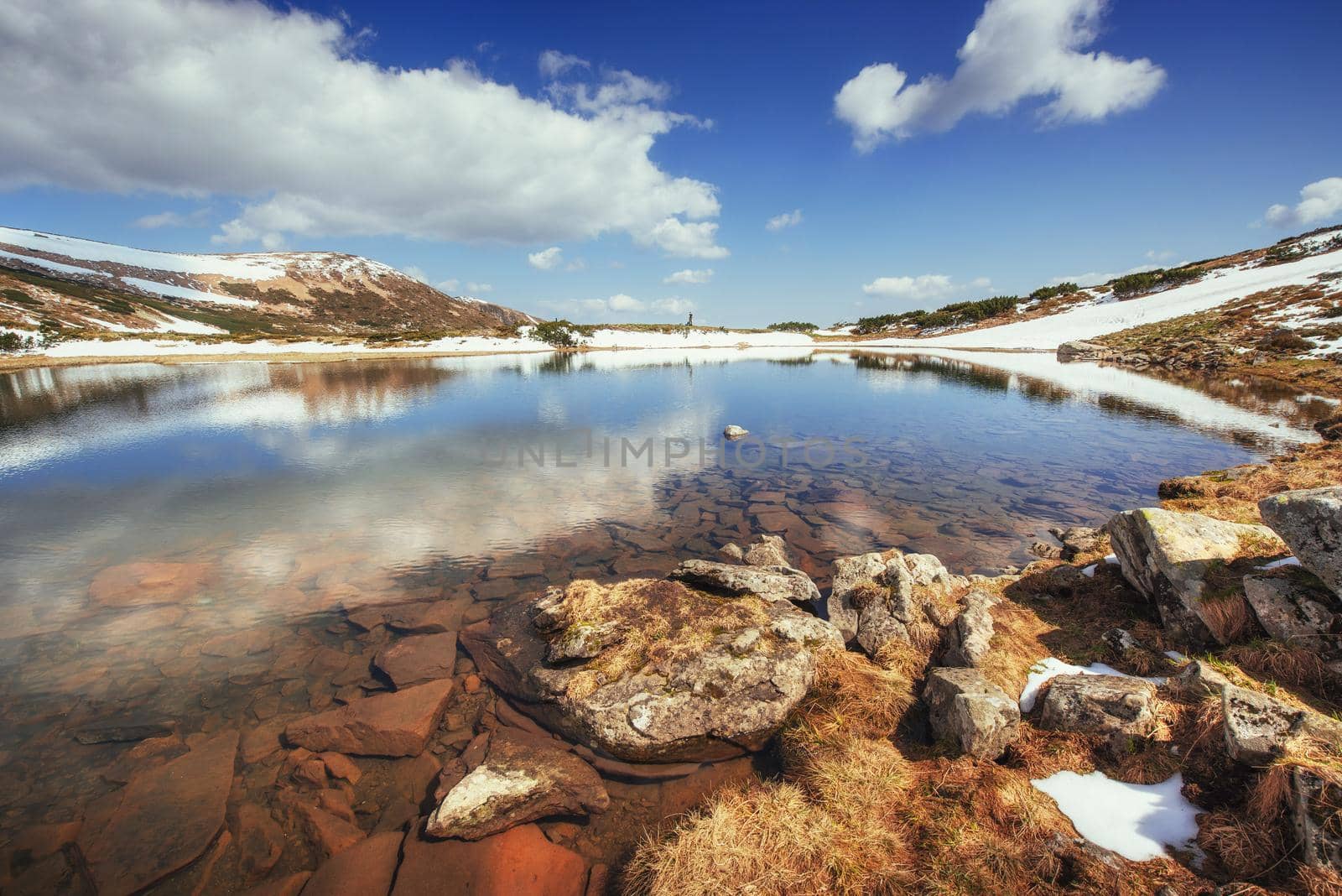 Lake between mountains. Spring landscape. Carpathians Ukraine Europe