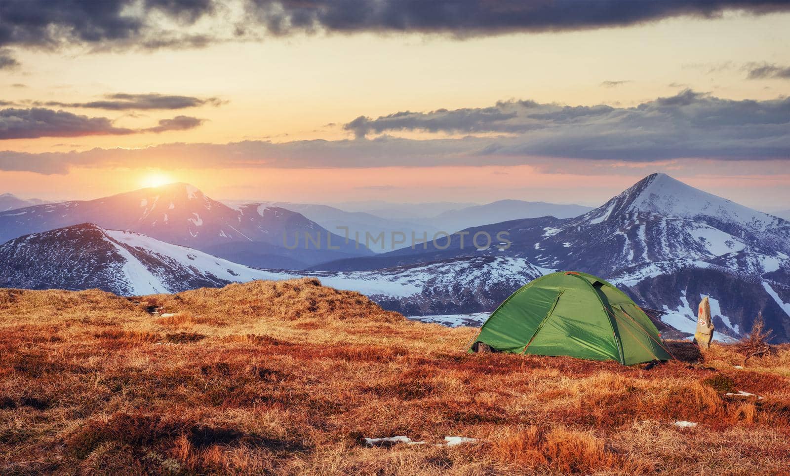 The tent is made up of green in the Carpathians. Spring mountain landscape. Ukraine. Europe.