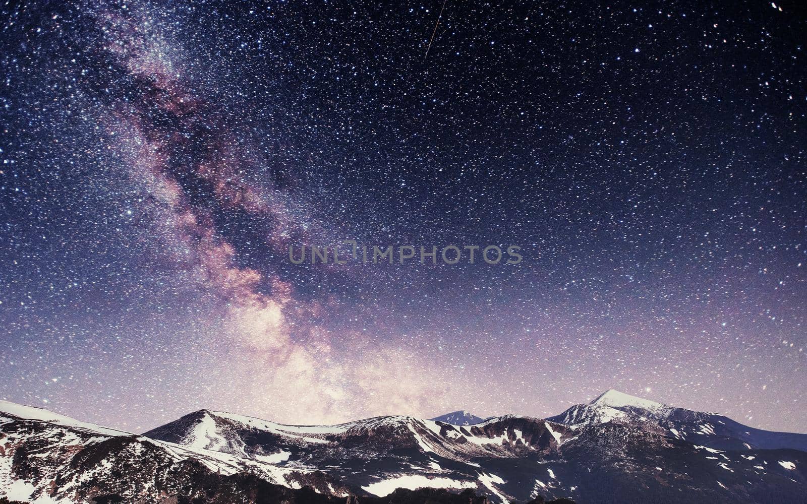 Spring mountain landscape. Fantastic starry sky. Carpathians Ukraine Europe