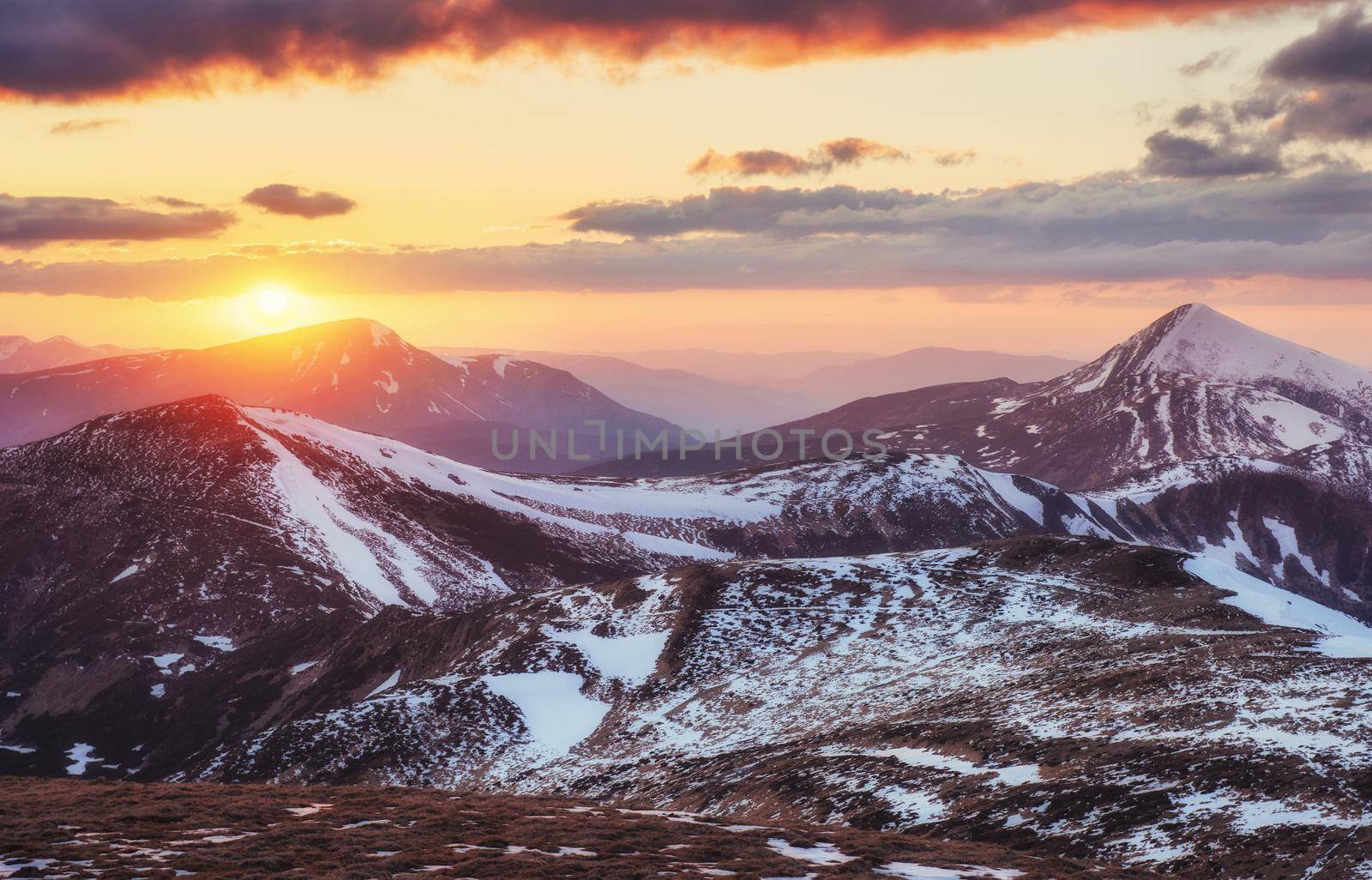 Colorful spring sunset over the mountain ranges in the national park Carpathians. Ukraine, Europe.