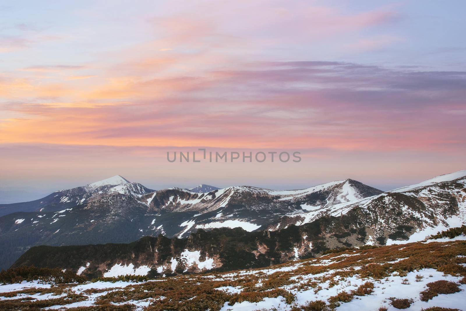 Colorful spring sunset over the mountain ranges in the national park Carpathians. Ukraine, Europe.