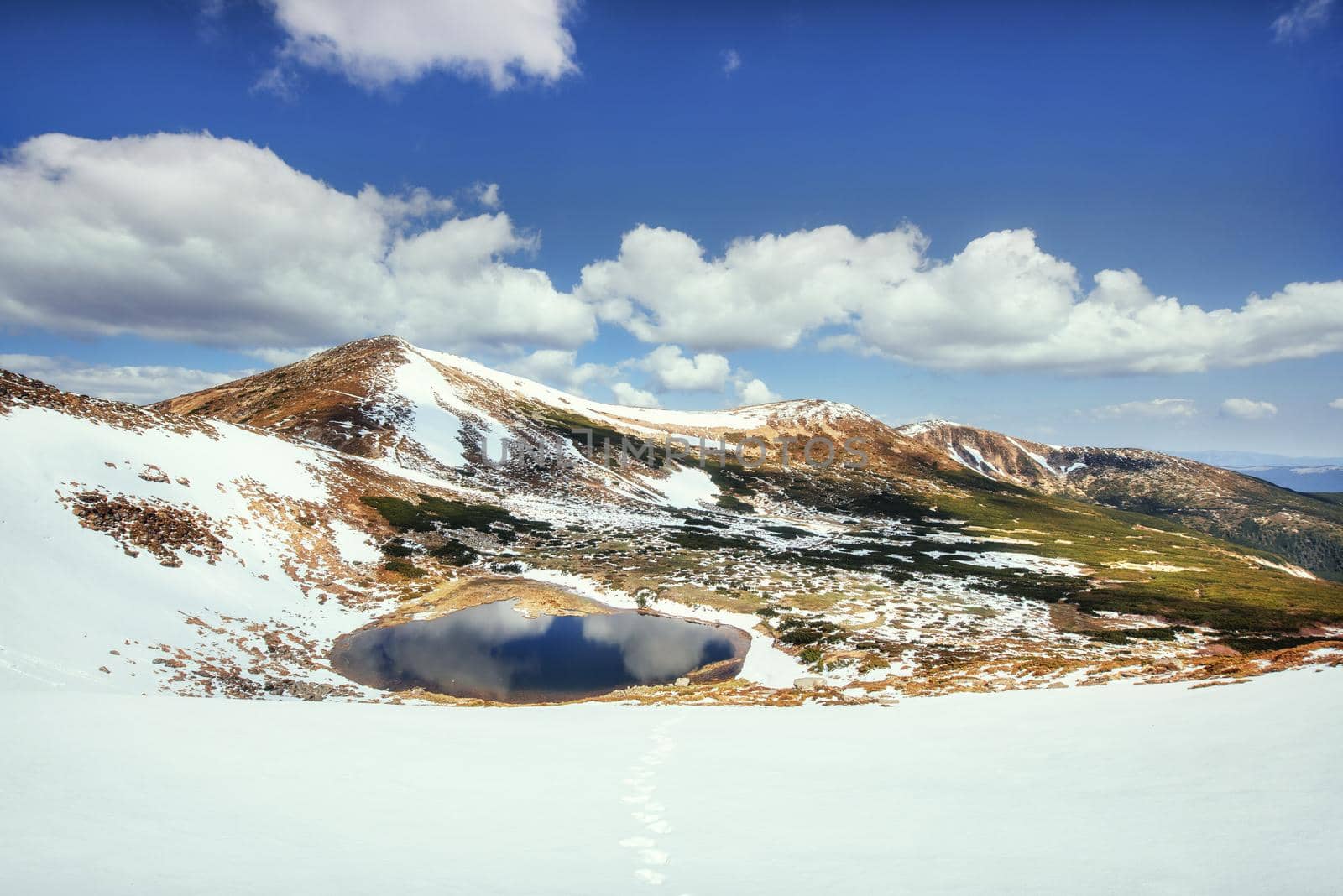 Mountain Lake. Reflection of sky in water. Spring landscape. Carpathians Ukraine Europe