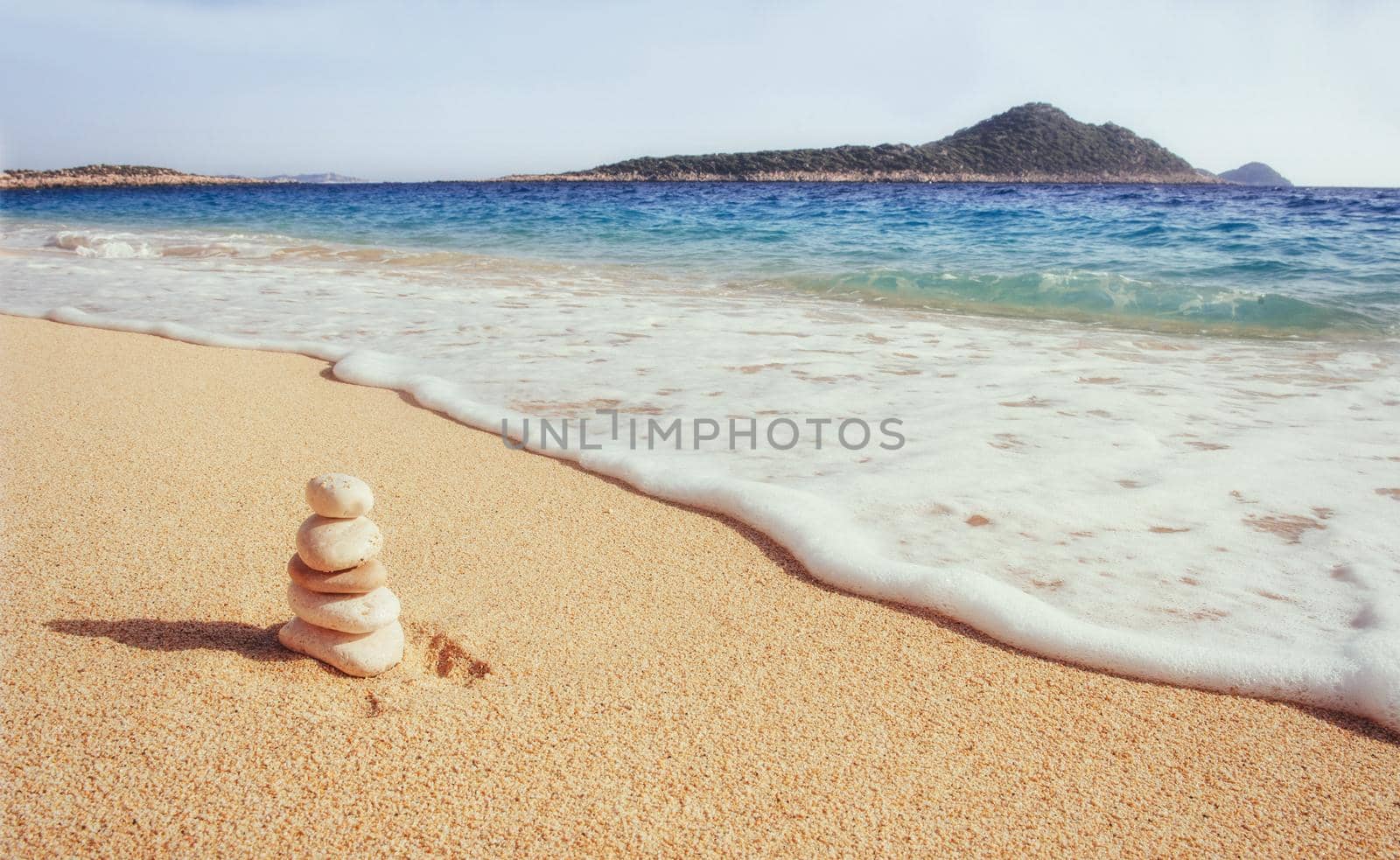 Scenic view of sandy beach and surf waves on the shore