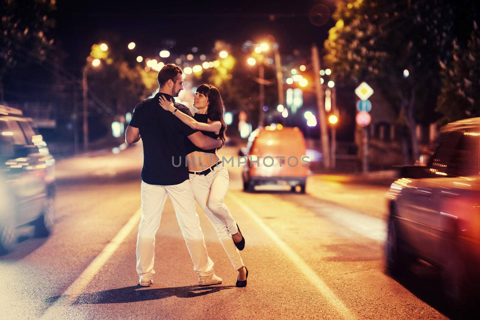 young couple dancing on the road by Standret