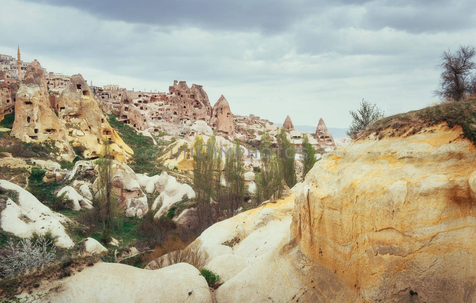 Ancient town and a castle of Uchisar dug from a mountains after sunrise, Cappadocia, Turkey