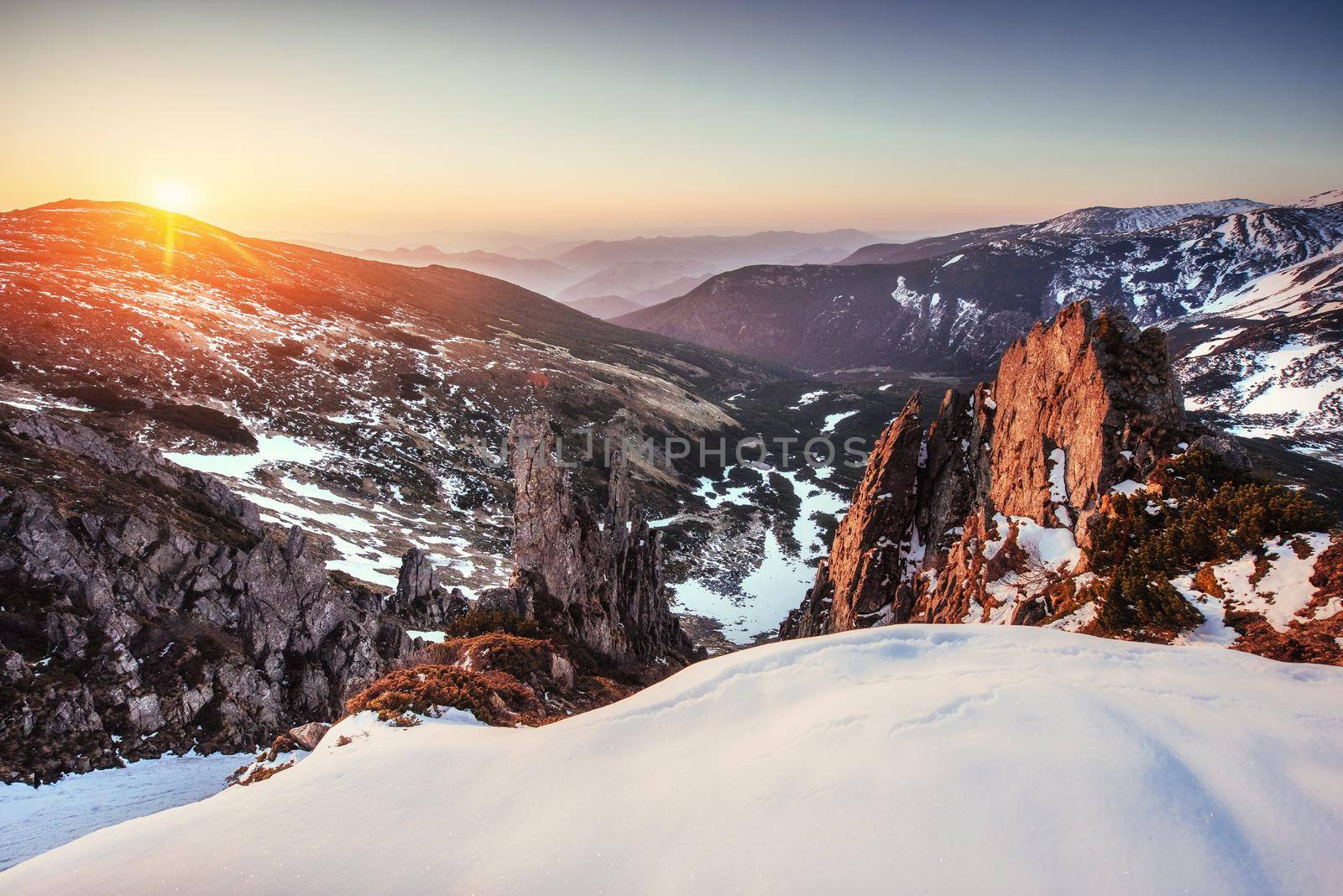 Colorful spring sunset over the mountain ranges in the national park Carpathians. Ukraine, Europe.