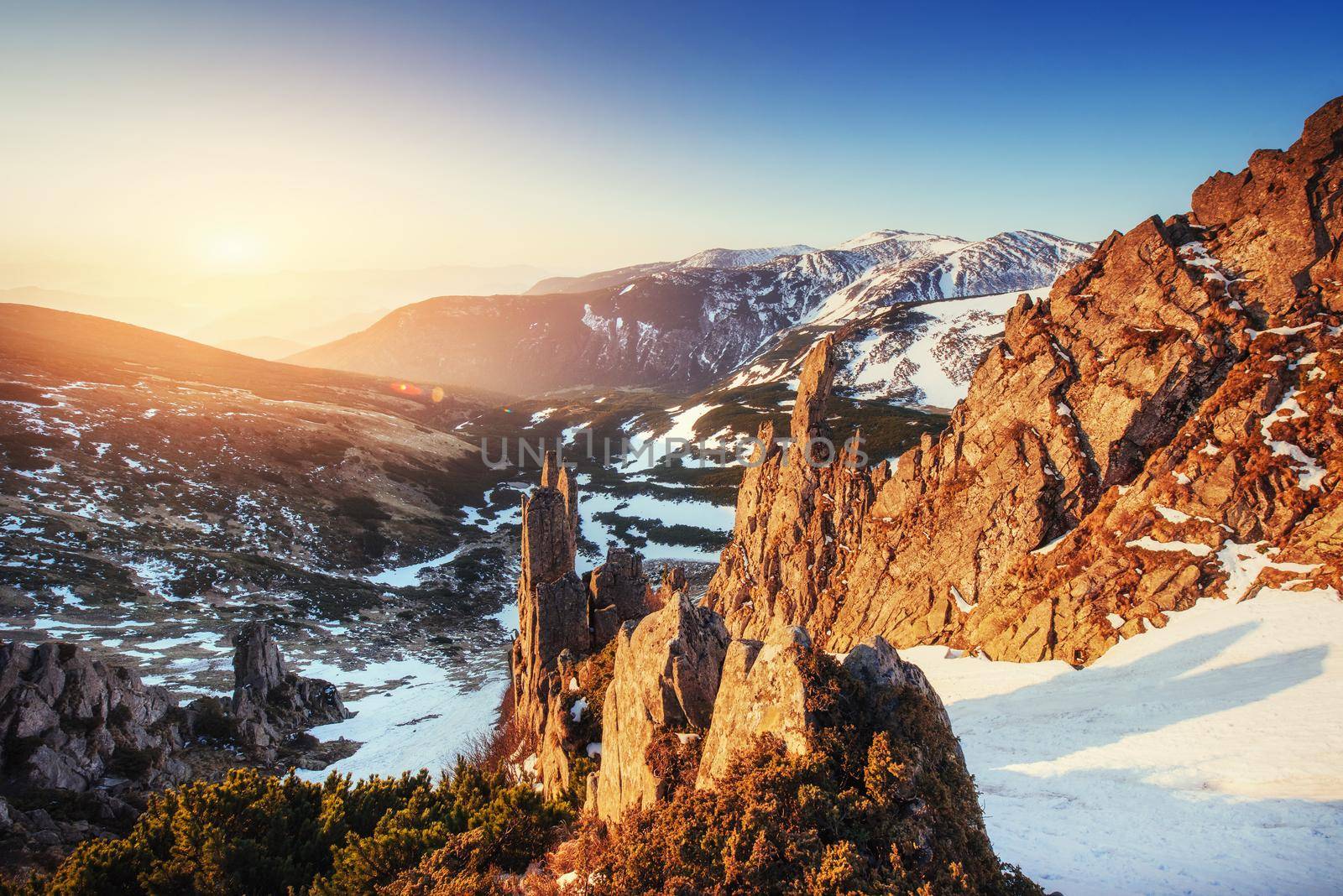 Colorful spring sunset over the mountain ranges in the national park Carpathians. Ukraine, Europe.