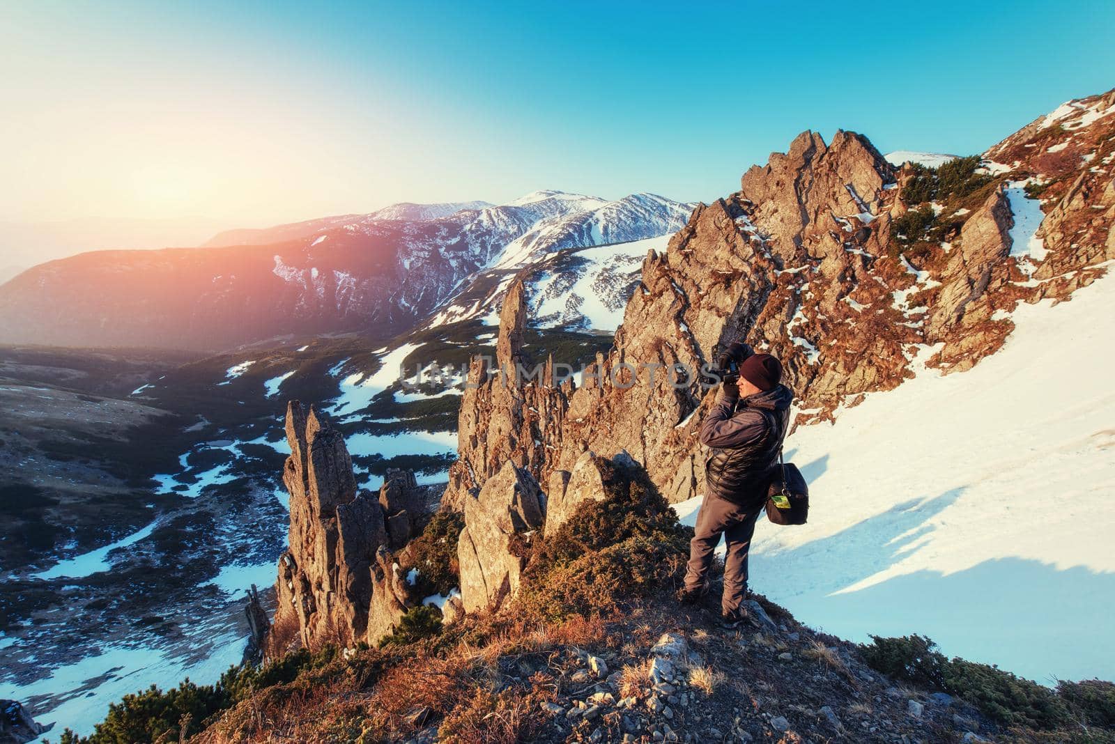 tourist looks at the landscape. Beautiful sunset. Spring landscape. Carpathians Ukraine Europe