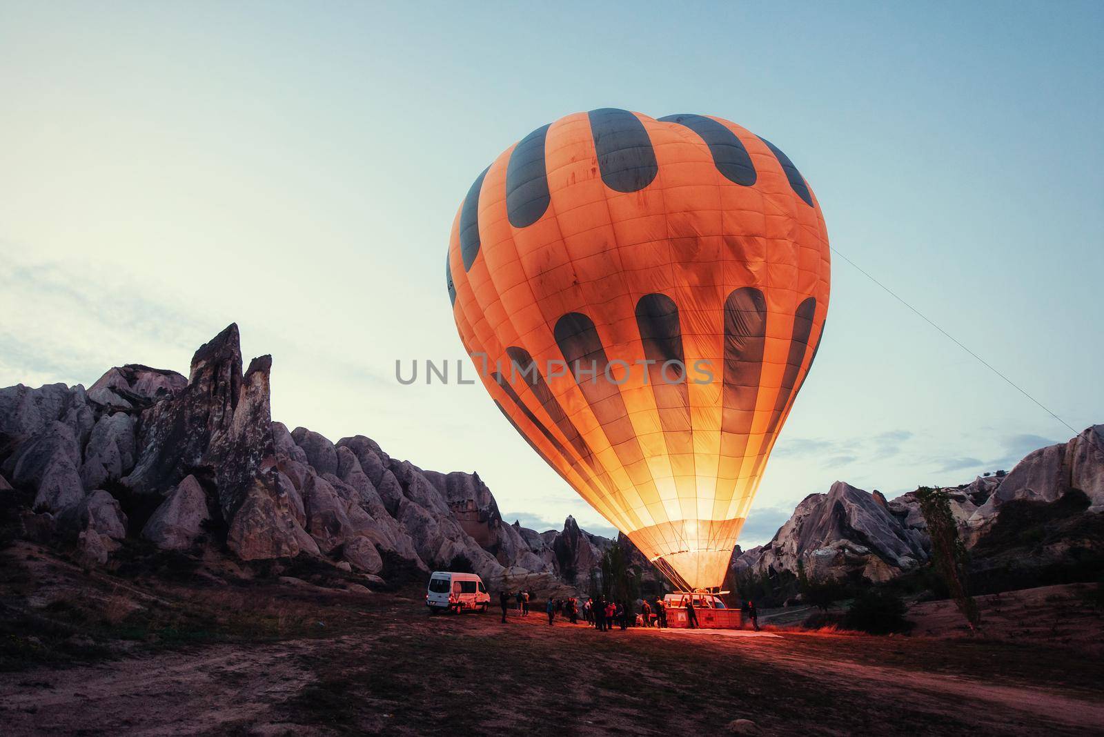 Cappadocia, Turkey. The first crew of flame and heat for inflating the balloon before launch. Balloon is one of the most famous of that trip will have to do in Cappadocia