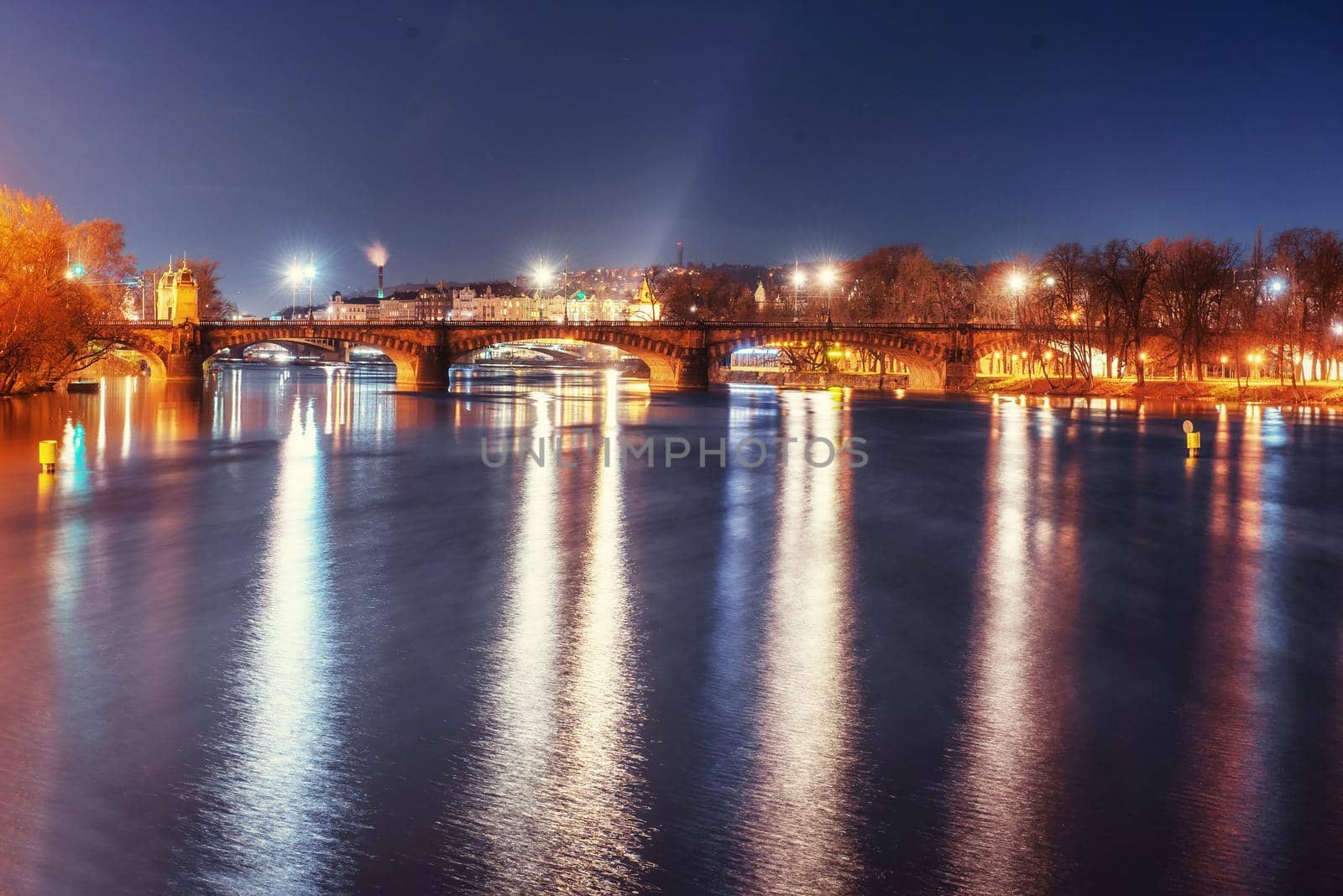 Scenic view of bridges on the Vltava river and of the historical center of Prague: buildings and landmarks of old town with red rooftops.