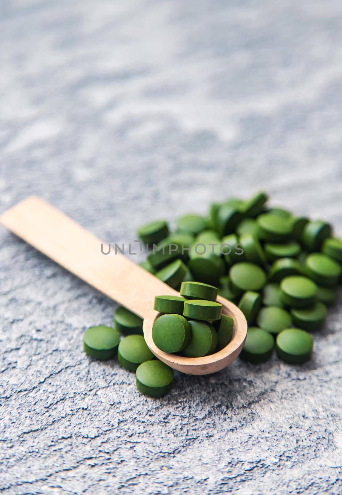 Green pills of chlorella and spirulina. Selective focus by mila1784