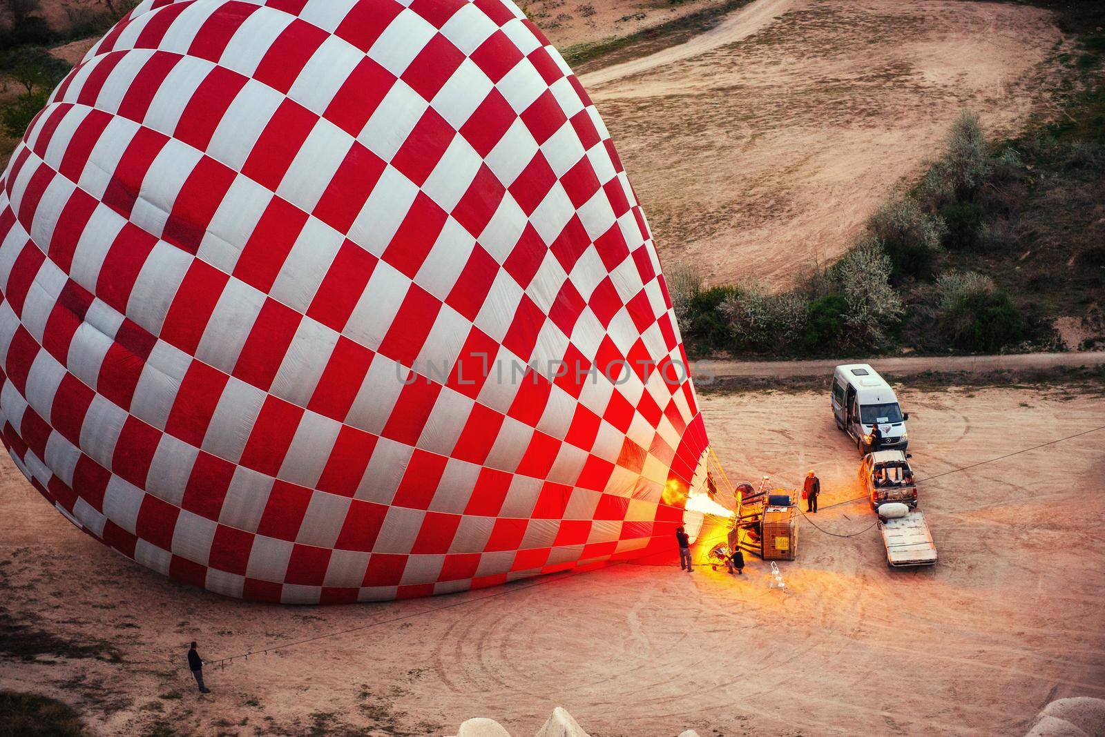 Cappadocia, Turkey. The first crew of flame and heat for inflating the balloon before launch. Balloon is one of the most famous of that trip will have to do in Cappadocia