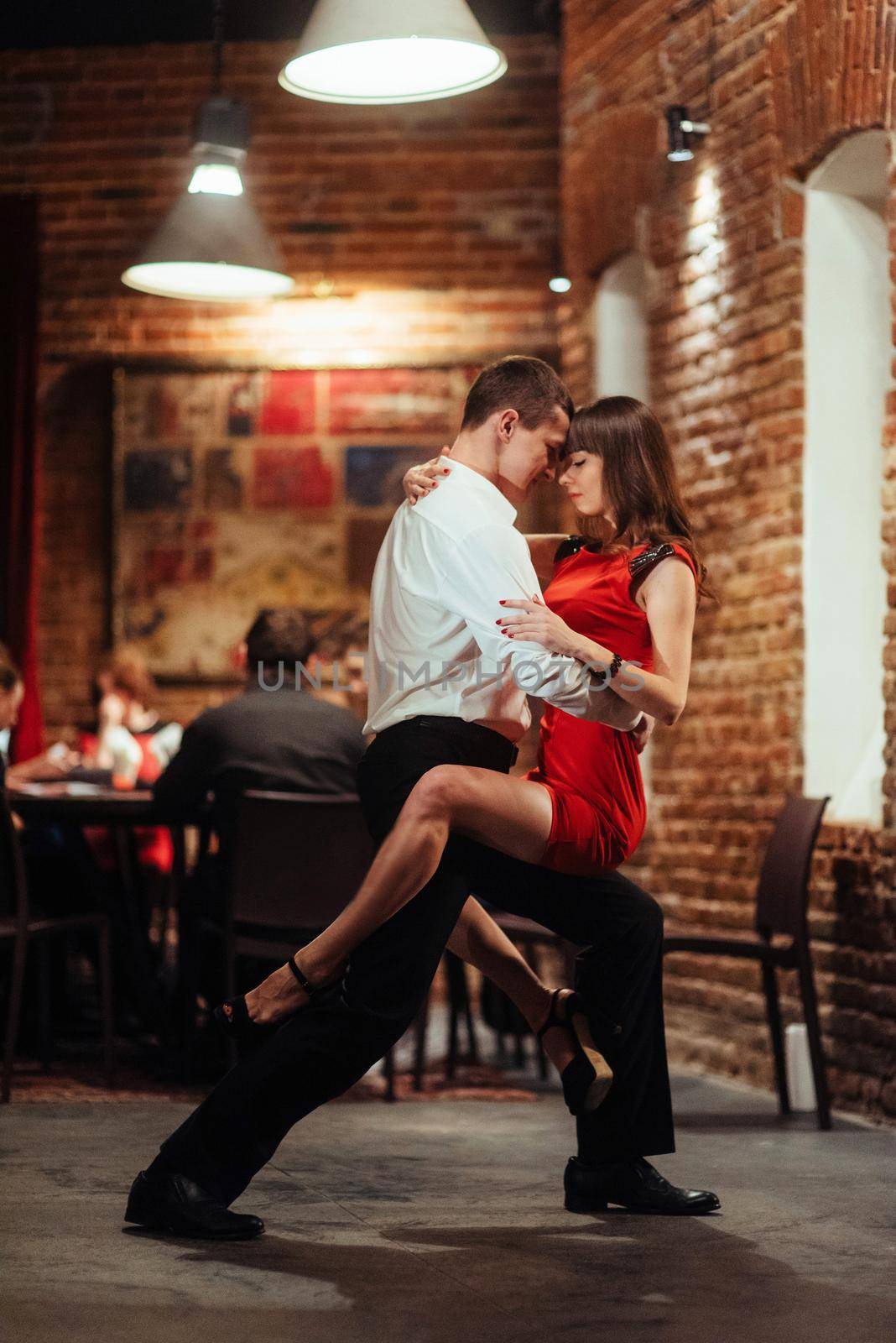 Dancing young couple on a white background. Passionate salsa