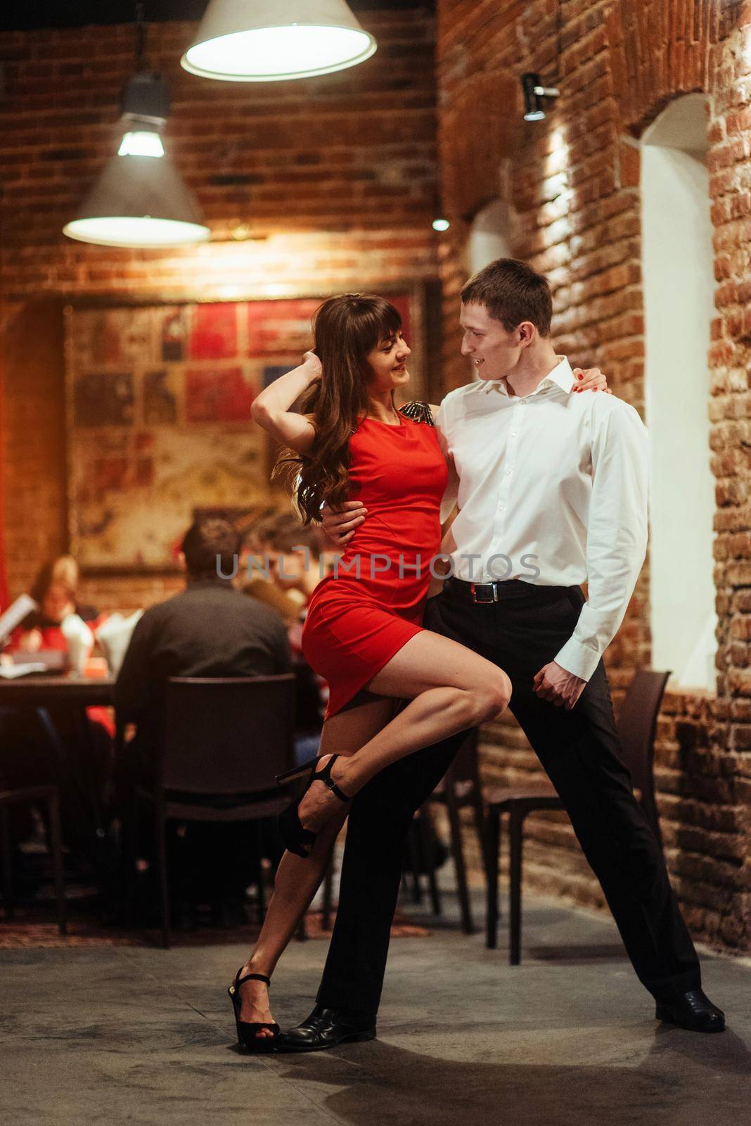 Dancing young couple on a white background. Passionate salsa. by Standret