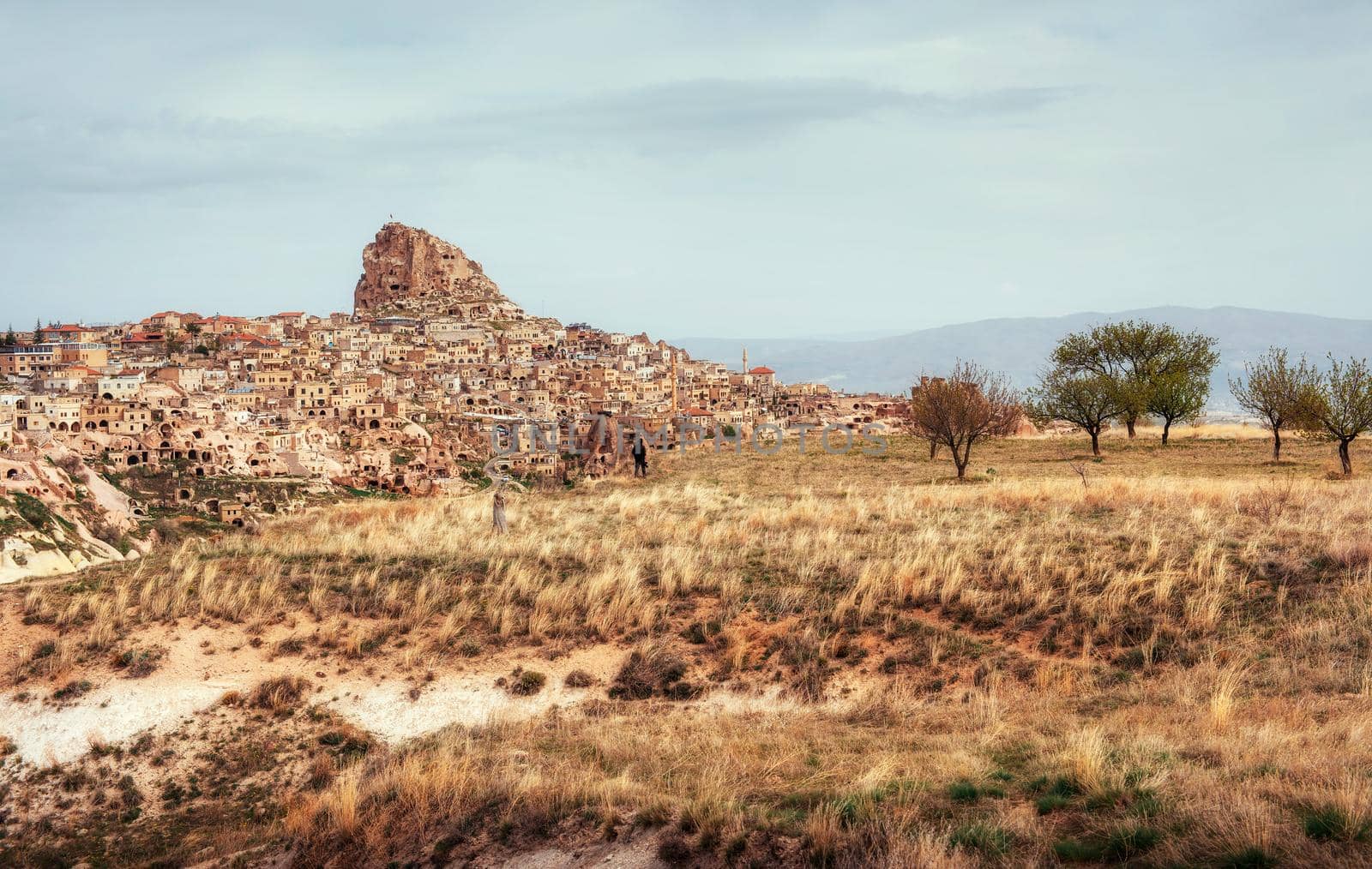 Ancient town and a castle of Uchisar dug from a mountains after sunrise, Cappadocia, Turkey