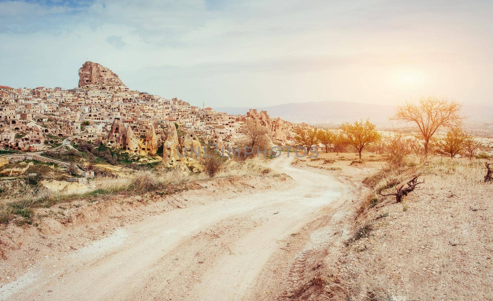 Ancient town and a castle of Uchisar dug from a mountains after sunrise, Cappadocia, Turkey