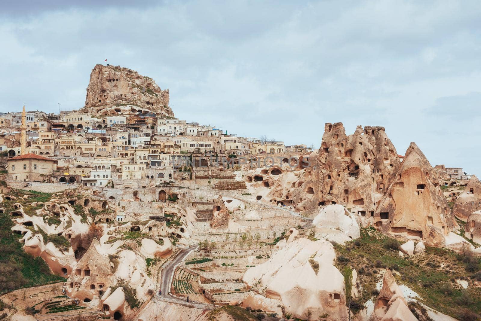 Ancient town and a castle of Uchisar dug from a mountains after sunrise, Cappadocia, Turkey