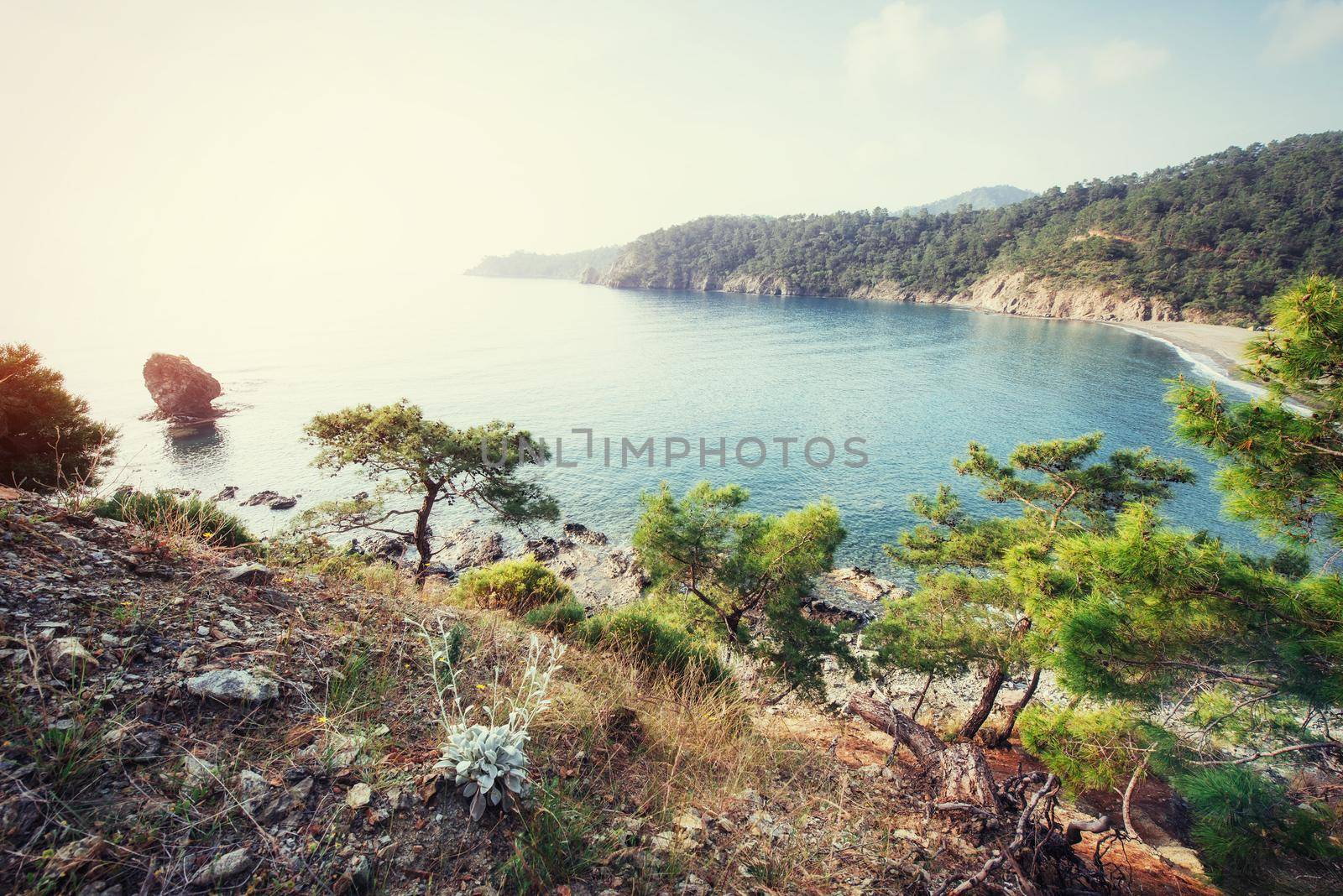Beautiful sandy road that video into the mountains overlooking the sea.