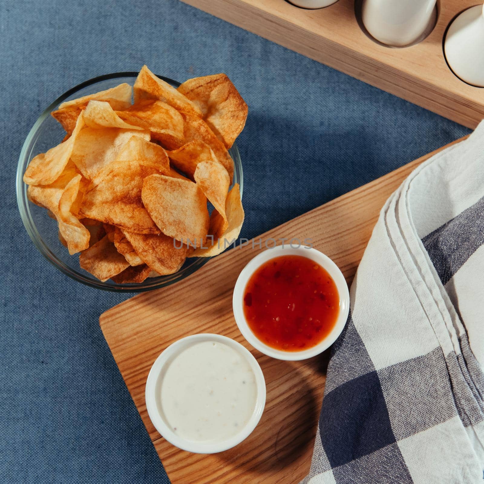 Potato chips with sauce on the table. Homemade sauces.