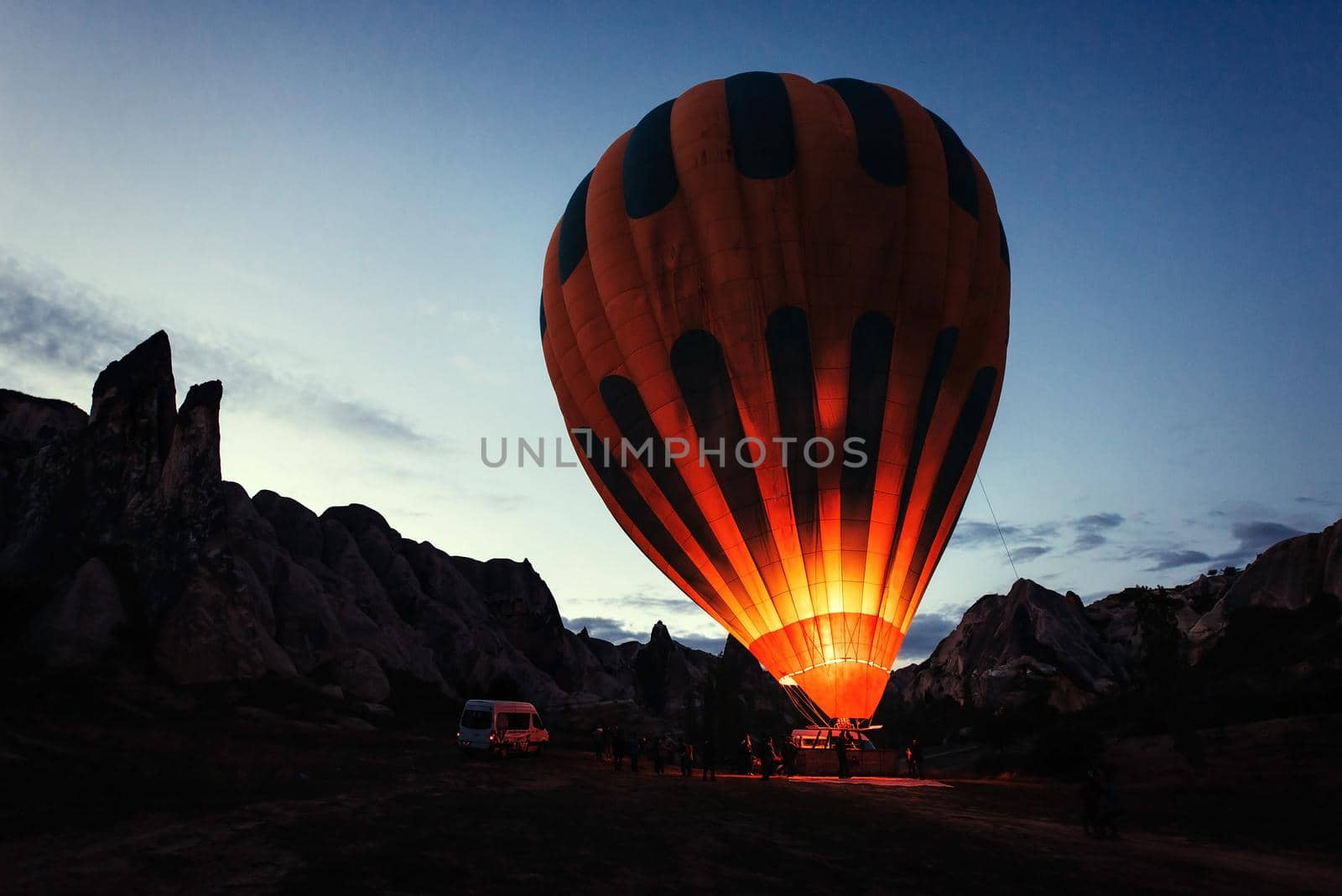 Cappadocia, Turkey. The first crew of flame and heat for inflating the balloon before launch. Balloon is one of the most famous of that trip will have to do in Cappadocia