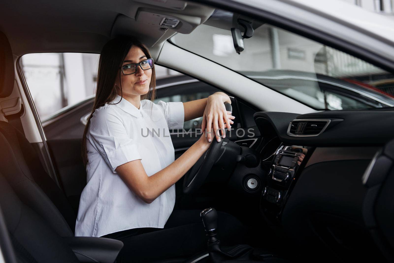 portrait of young beautiful woman sitting in the car.