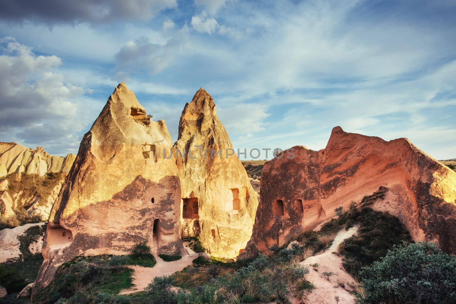 Unique geological formations in valley in Cappadocia, Central Anatolia, Turkey. Cappadocian Region with its valley and hills located between the volcanic mountains.