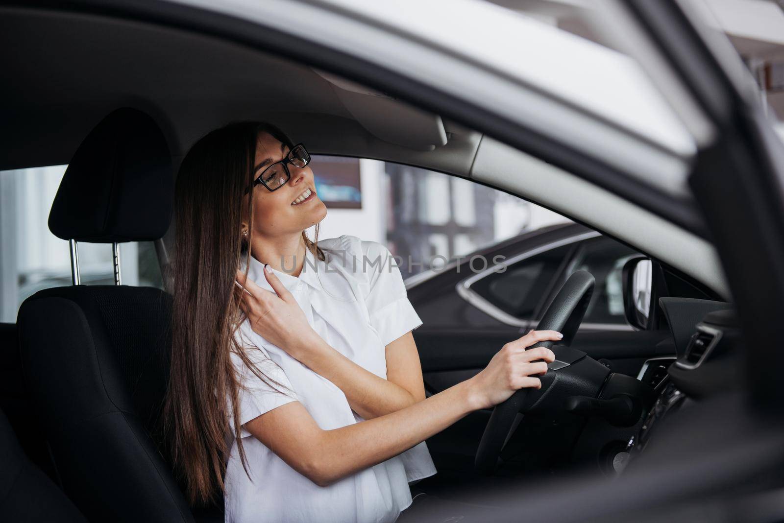 portrait of young beautiful woman sitting in the car.