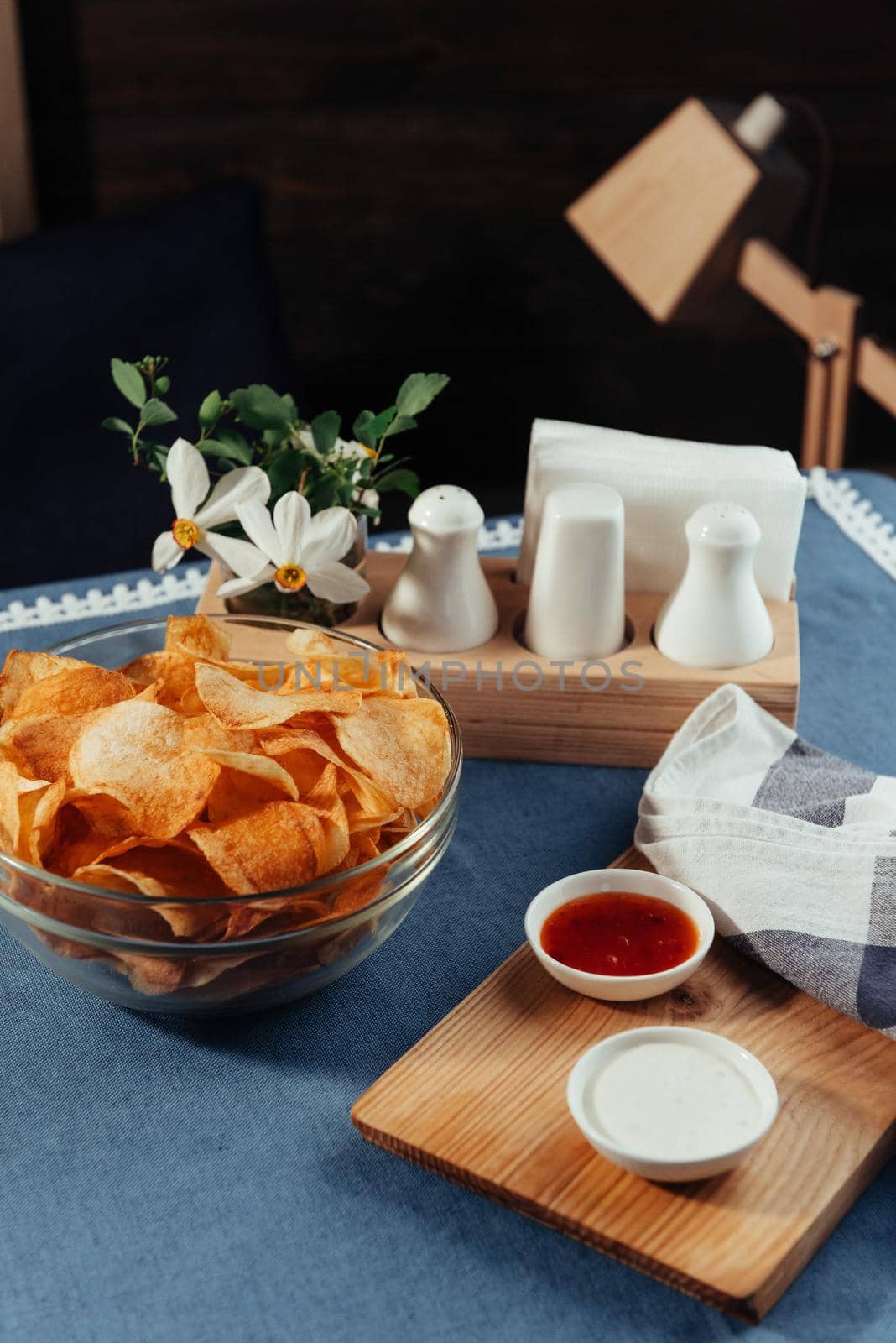 Potato chips with sauce on the table. Homemade sauces.