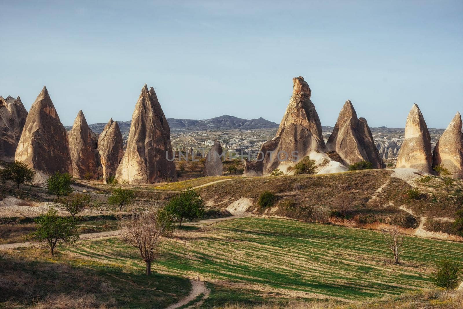 Review unique geological formations in Cappadocia, Turkey. Kappadokiets region, with its valleys, gorges, hills, located between the volcanic mountains in Goreme National Park.